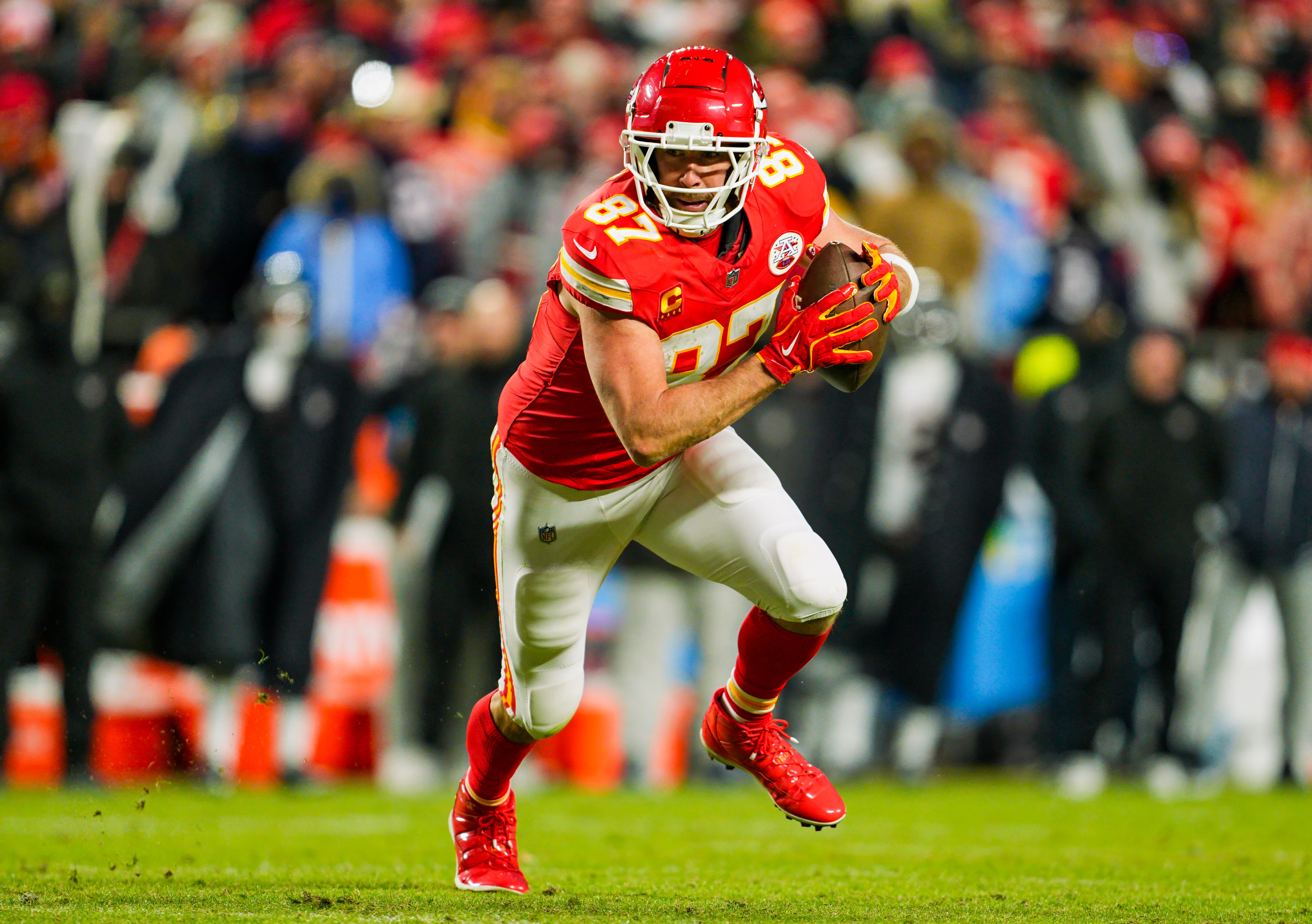 Jan 18, 2025; Kansas City, Missouri, USA; Kansas City Chiefs tight end Travis Kelce (87) runs with the ball during the second half against Houston Texans in a 2025 AFC divisional round game at GEHA Field at Arrowhead Stadium.
