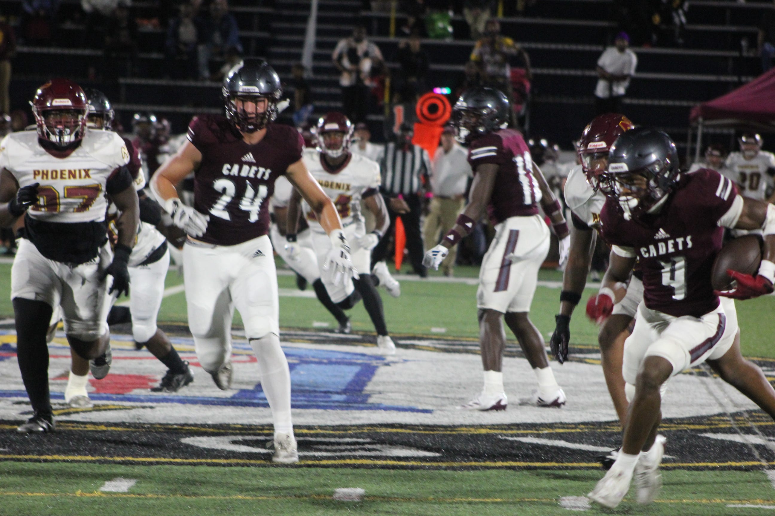 Benedictine's Bubba Frazier (No. 4) tries to get to the edge while John Lilly (No. 24) looks to make a block in a win over New Hampstead at Memorial Stadium on Oct. 31, 2024.