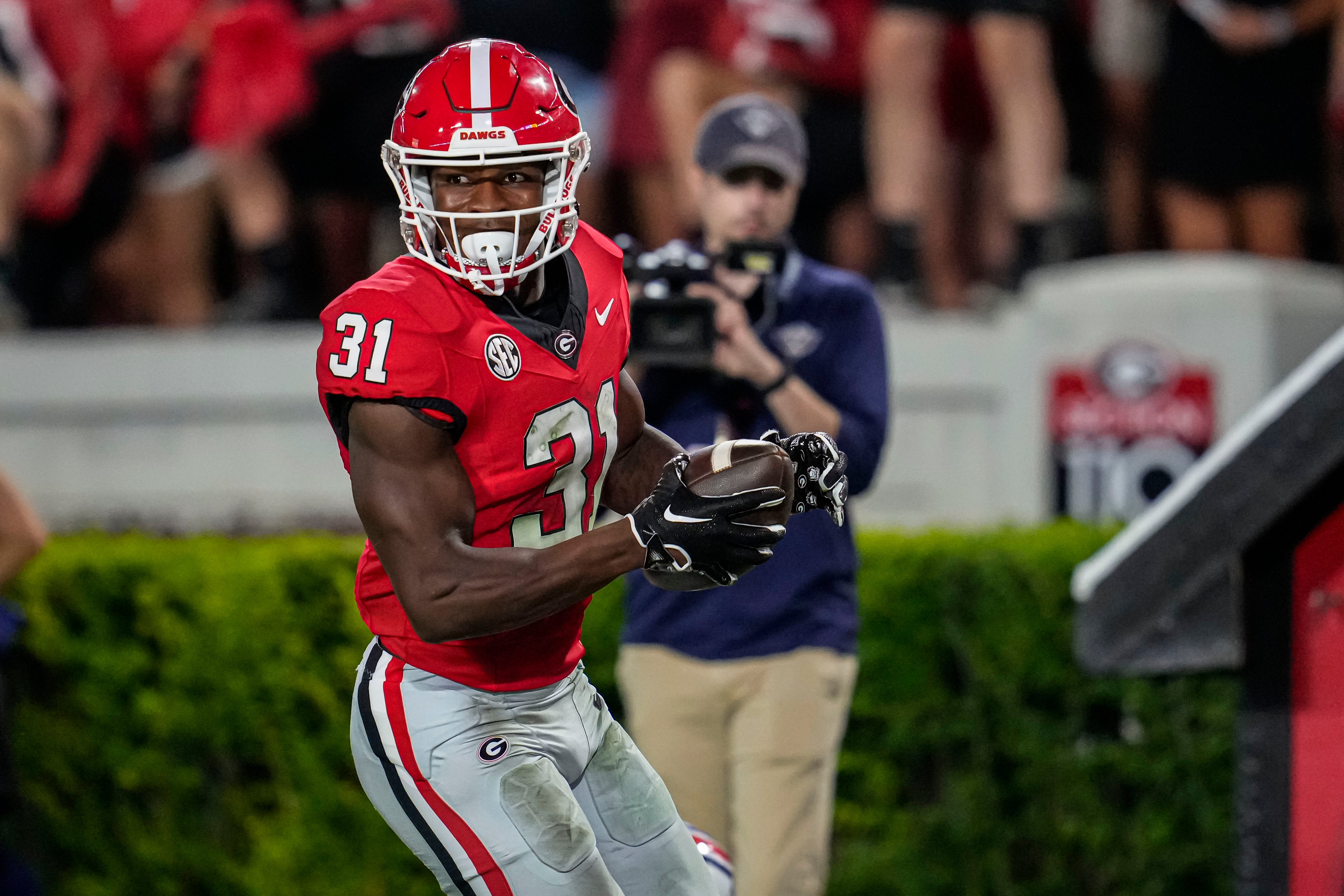 Georgia Bulldogs defensive player Kyron Jones (31) returns an interception for a touchdown against the Tennessee Martin Skyhawks during the second half at Sanford Stadium.