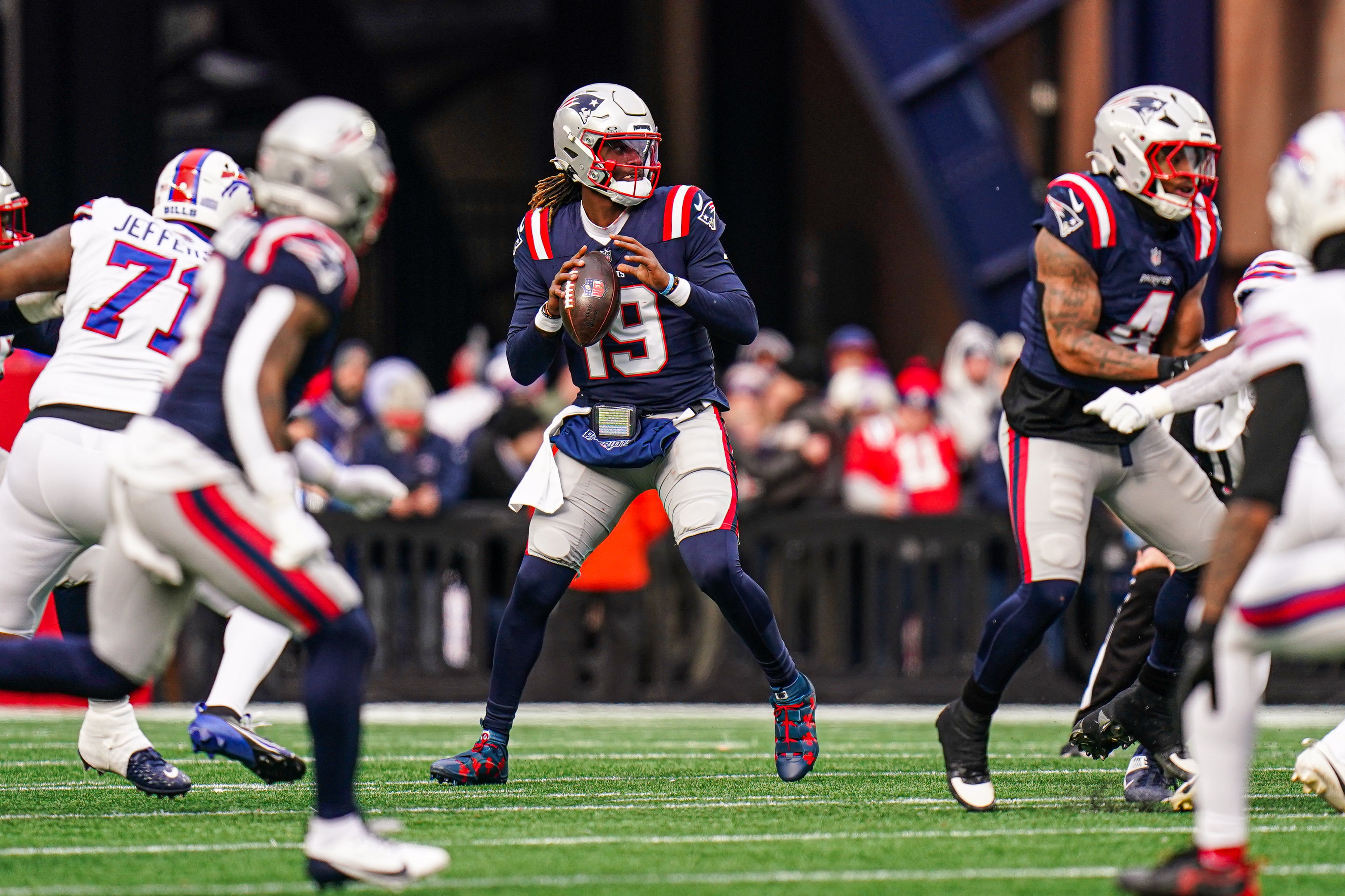 New England Patriots quarterback Joe Milton III (19) throws a pass against the Buffalo Bills in the first half at Gillette Stadium.