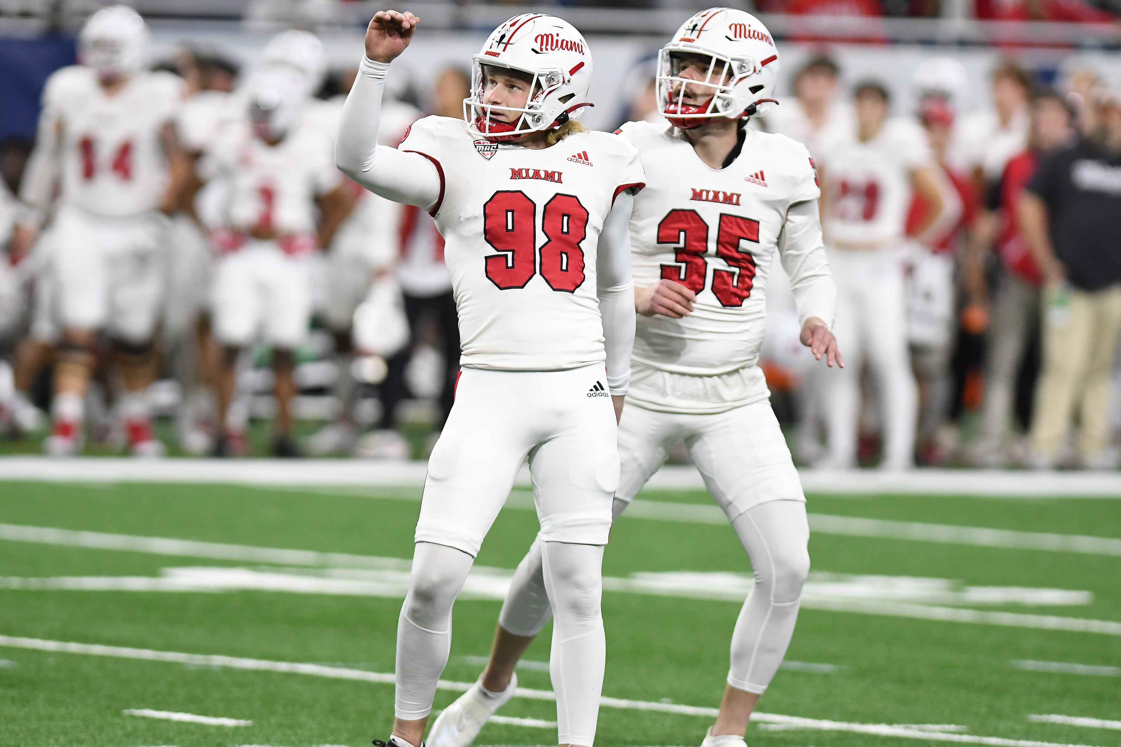 Dec 2, 2023; Detroit, MI, USA; Miami (OH) Redhawks place kicker Graham Nicholson (98) and holder Alec Bevelhimer (35) watch as a field goal by Nicholson goes through the uprights against the Toledo Rockets in the first quarter at Ford Field.