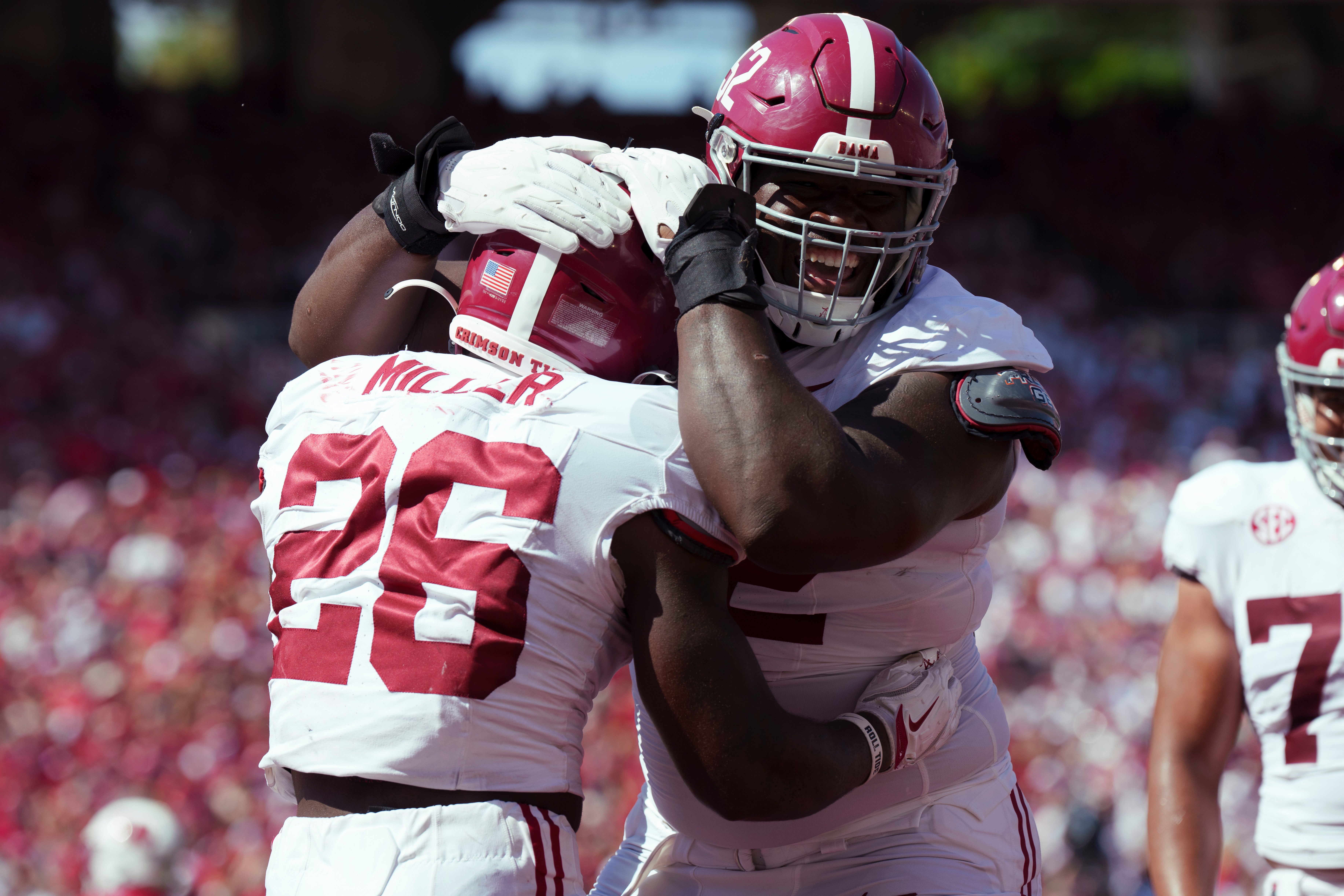 Sep 14, 2024; Madison, Wisconsin, USA; Alabama Crimson Tide running back Jam Miller (26) is greeted by offensive lineman Tyler Booker (52) after scoring a touchdown during the third quarter against the Wisconsin Badgers at Camp Randall Stadium.