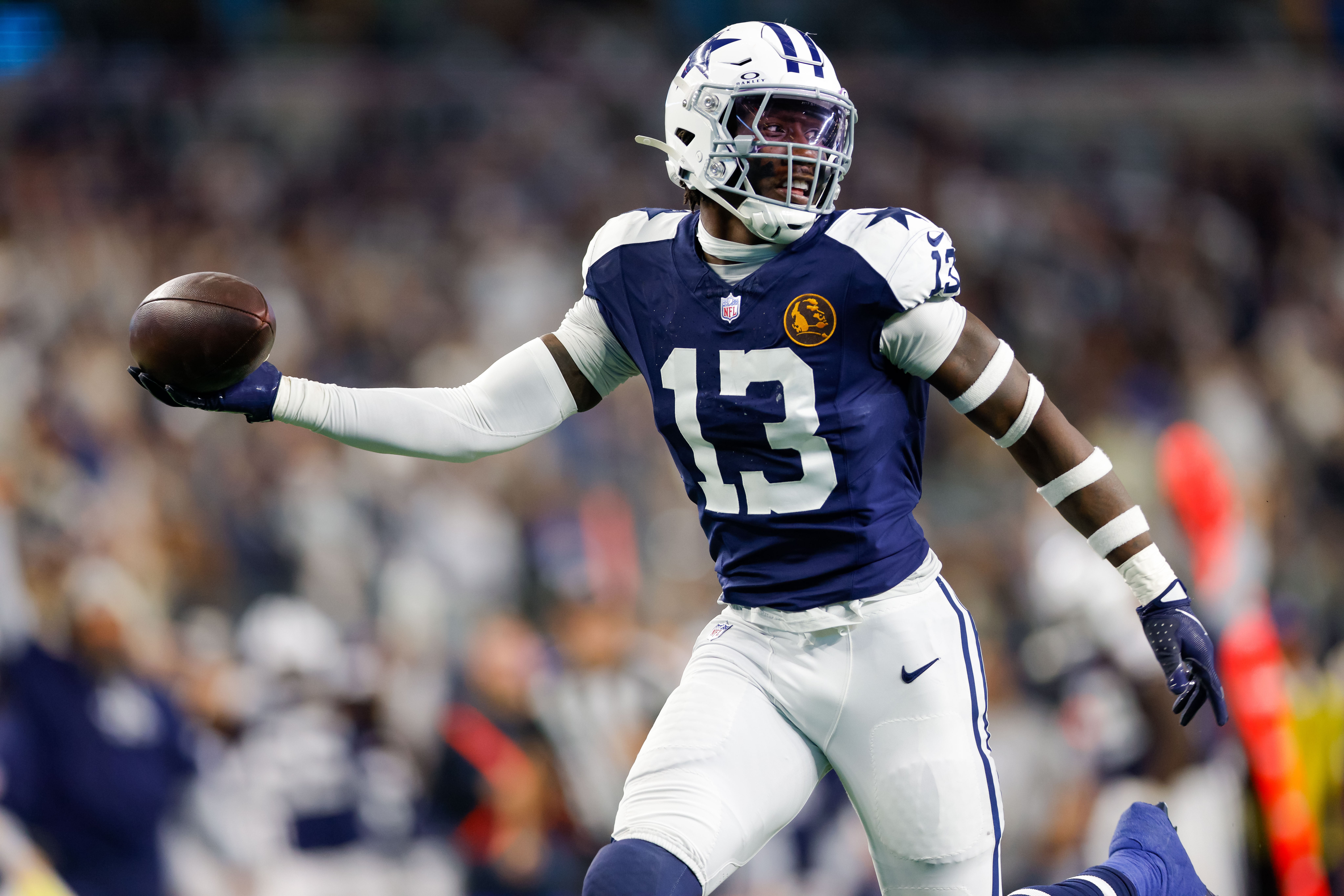 Dallas Cowboys linebacker DeMarvion Overshown (13) intercepts a pass and returns it for a touchdown during the second quarter against the New York Giants at AT&T Stadium.