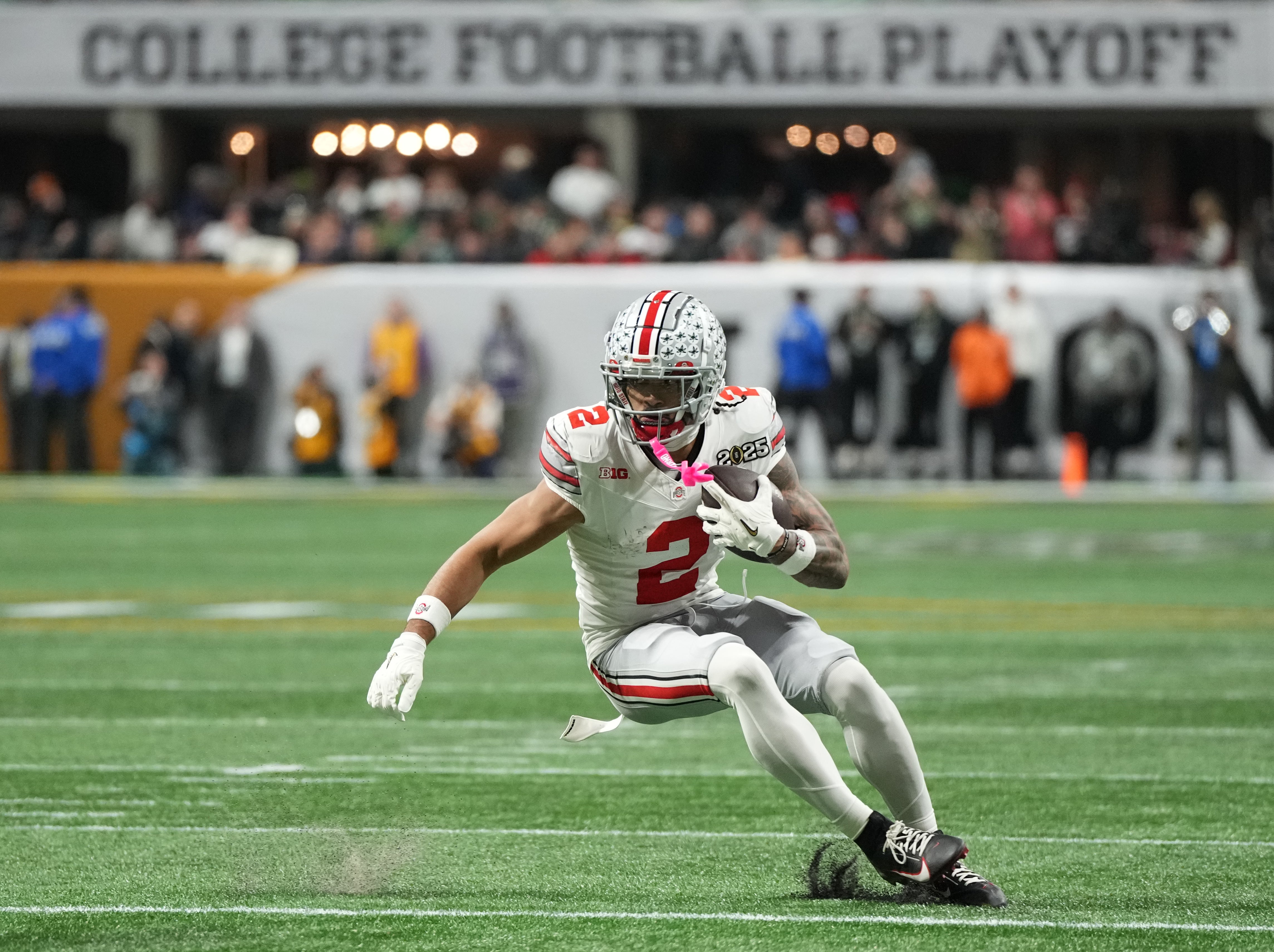 Ohio State Buckeyes wide receiver Emeka Egbuka (2) runs the ball against the Notre Dame Fighting Irish in the second half in the CFP National Championship college football game at Mercedes-Benz Stadium.