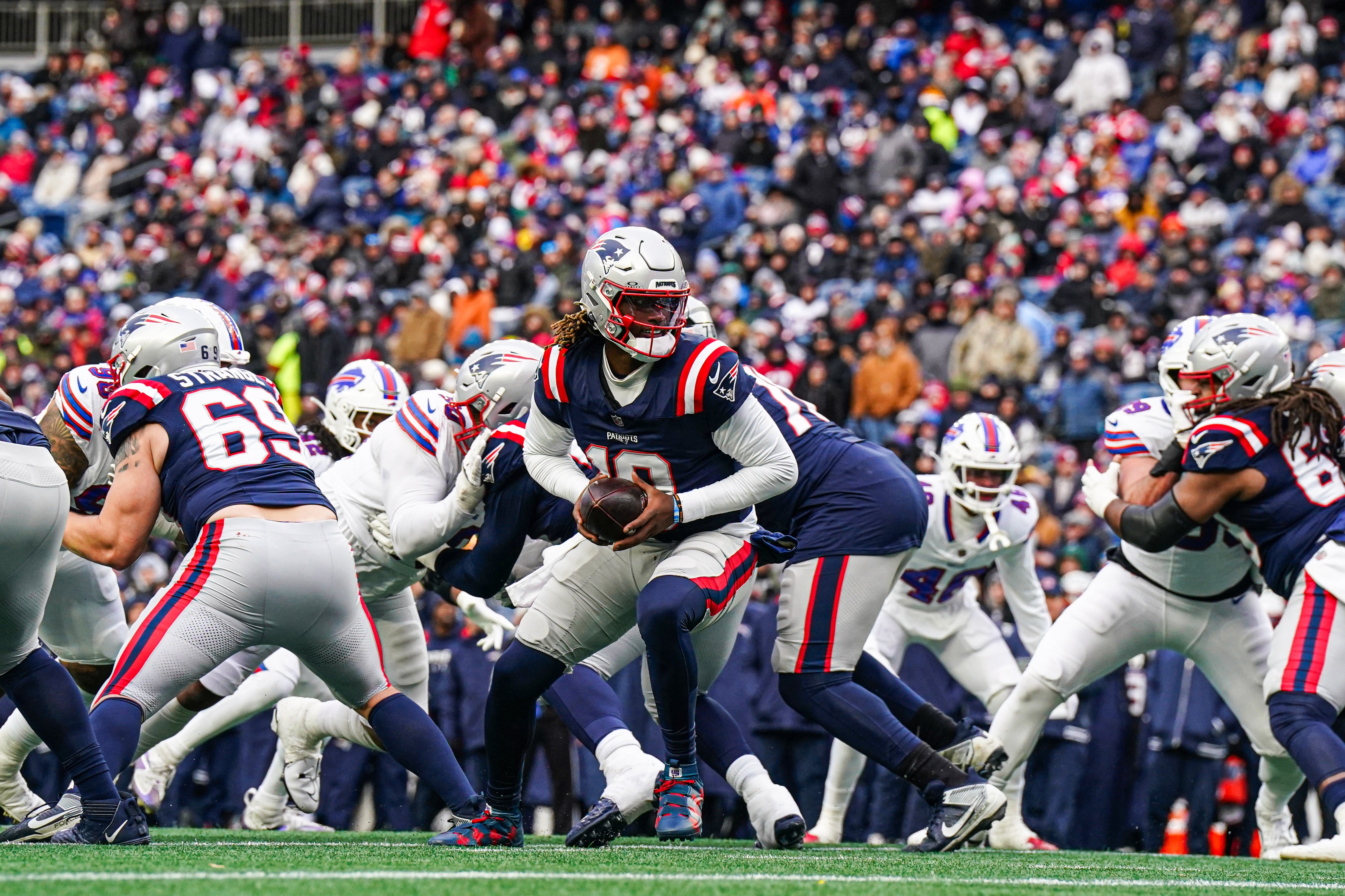 New England Patriots quarterback Joe Milton III (19) ready to hand off the ball against the Buffalo Bills in the second half at Gillette Stadium.