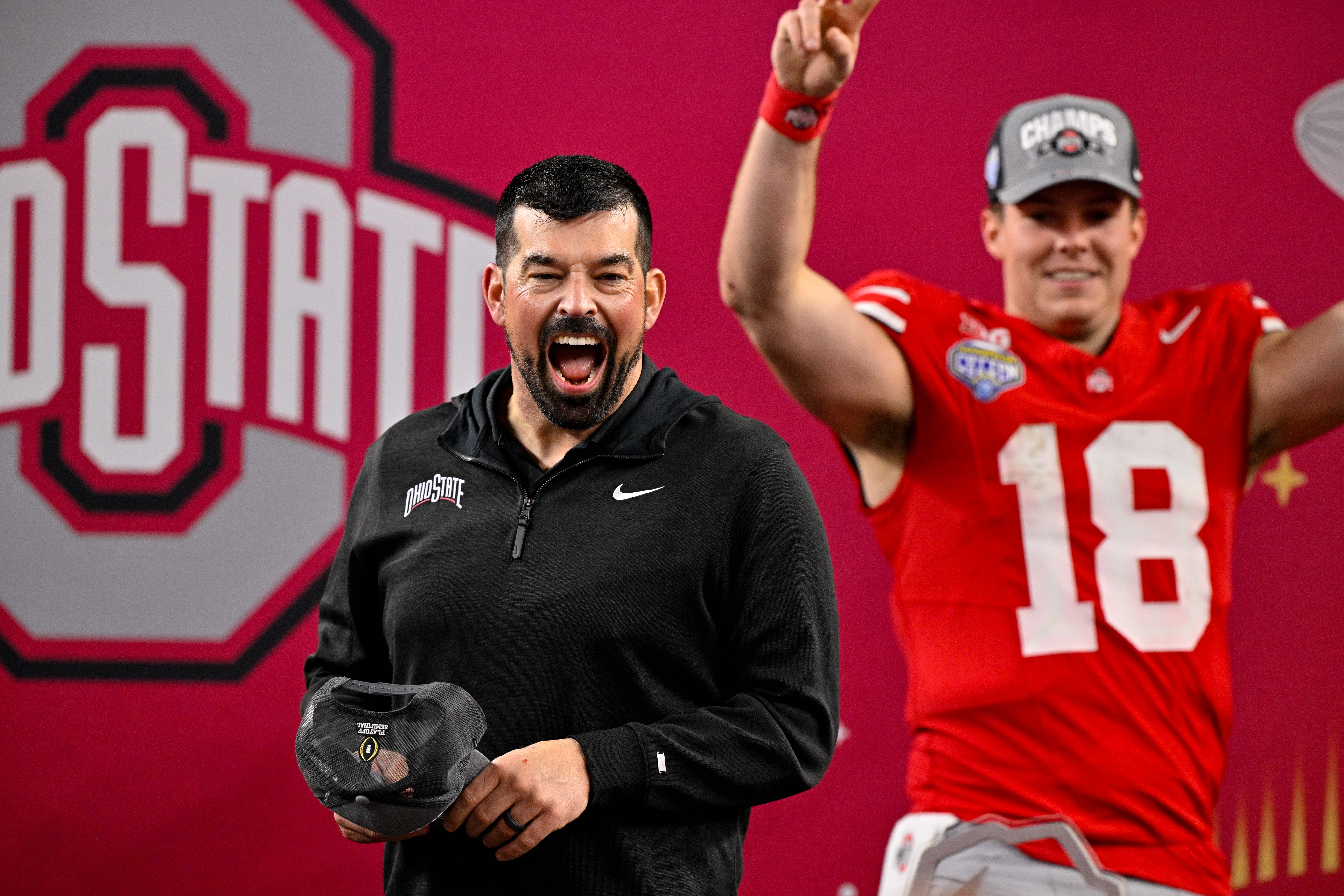 Ryan Day celebrates another win for Ohio State with his quarterback Will Howard in the background.