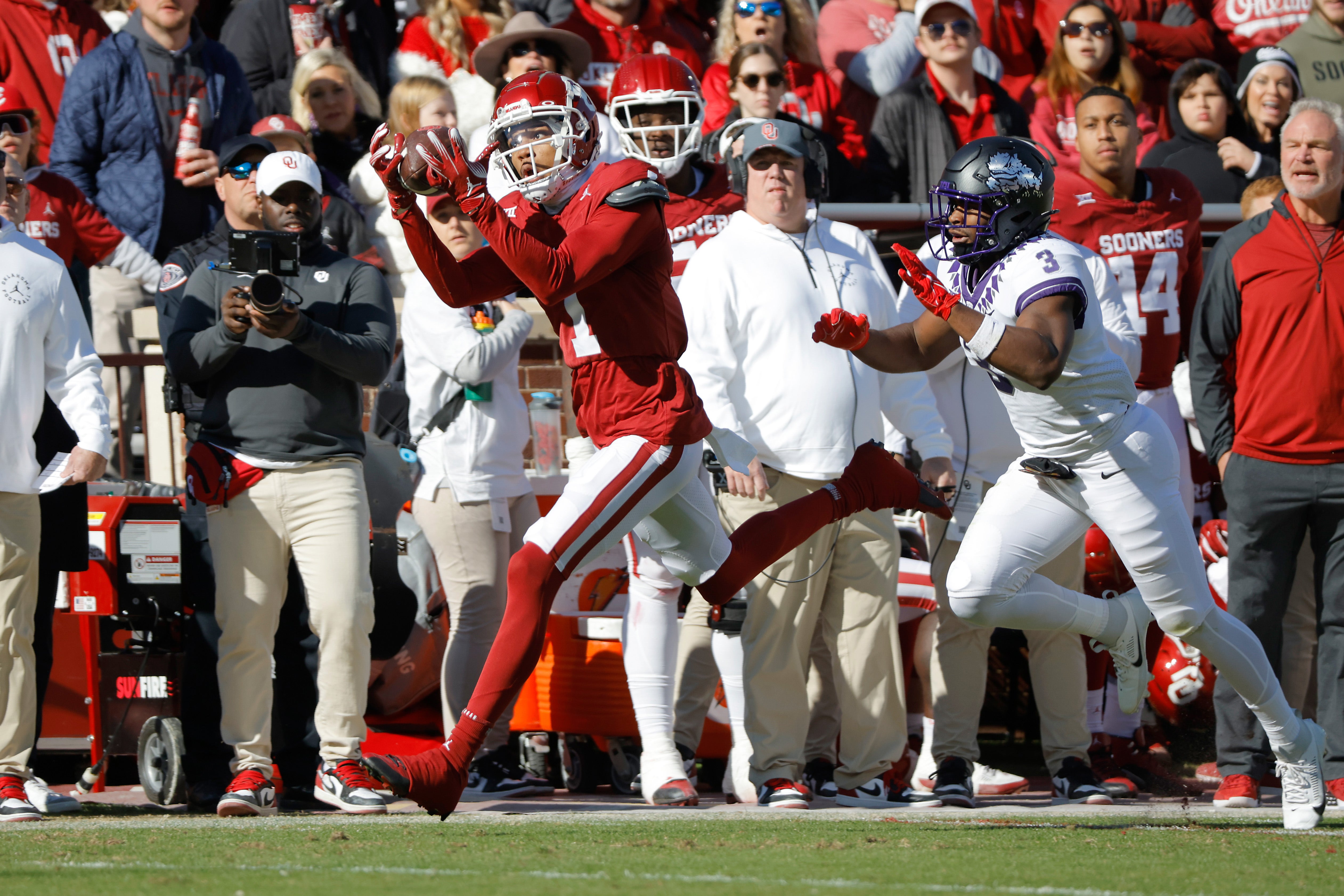 Nov 24, 2023; Norman, Oklahoma, USA; Oklahoma Sooners wide receiver Jayden Gibson (1) catchers a pass for a touchdown against TCU Horned Frogs safety Mark Perry (3) at Gaylord Family-Oklahoma Memorial Stadium.