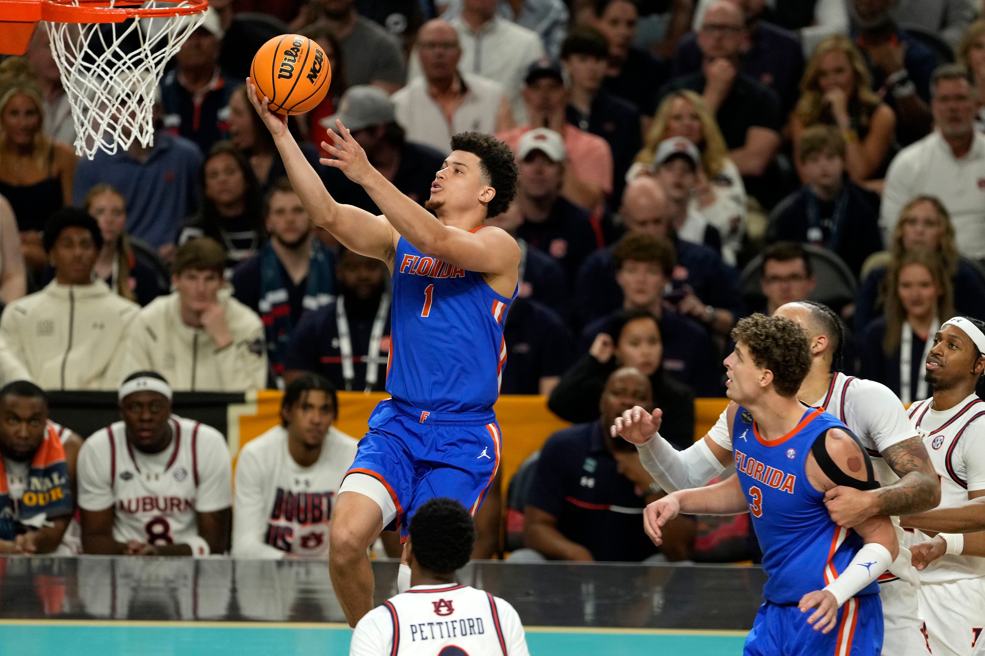 Apr 5, 2025; San Antonio, TX, USA; Florida Gators guard Walter Clayton Jr. (1) shoots the ball against the Auburn Tigers during the first half in the semifinals of the men's Final Four of the 2025 NCAA Tournament at Alamodome.