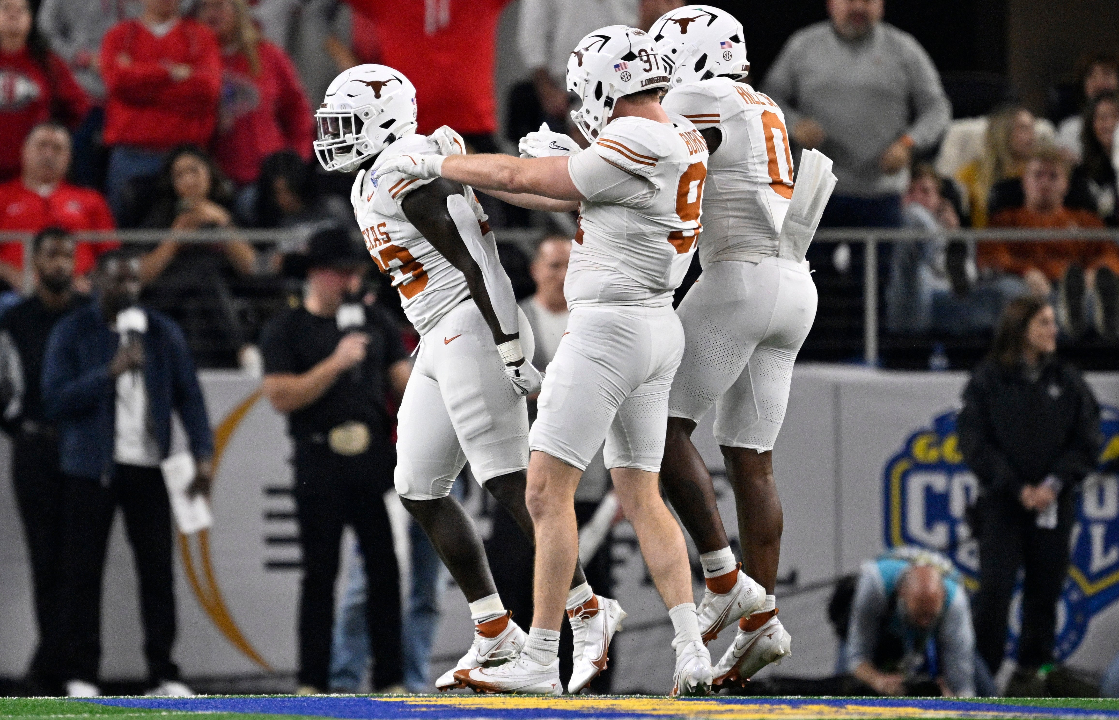 Anthony Hill Jr., LB Texas is celebrated by teammates after making a big defensive play.