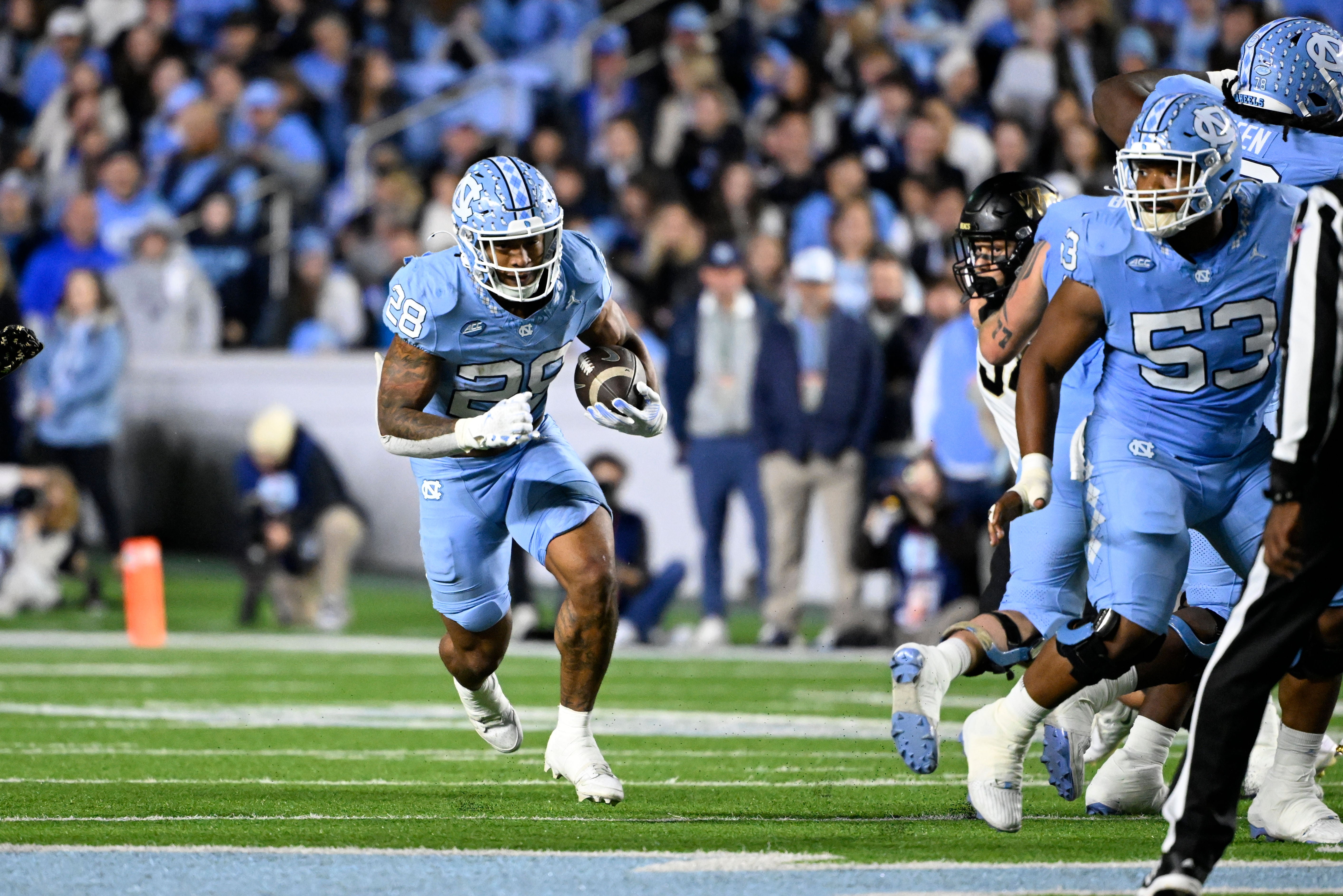 North Carolina Tar Heels running back Omarion Hampton (28) runs in the first quarter at Kenan Memorial Stadium.