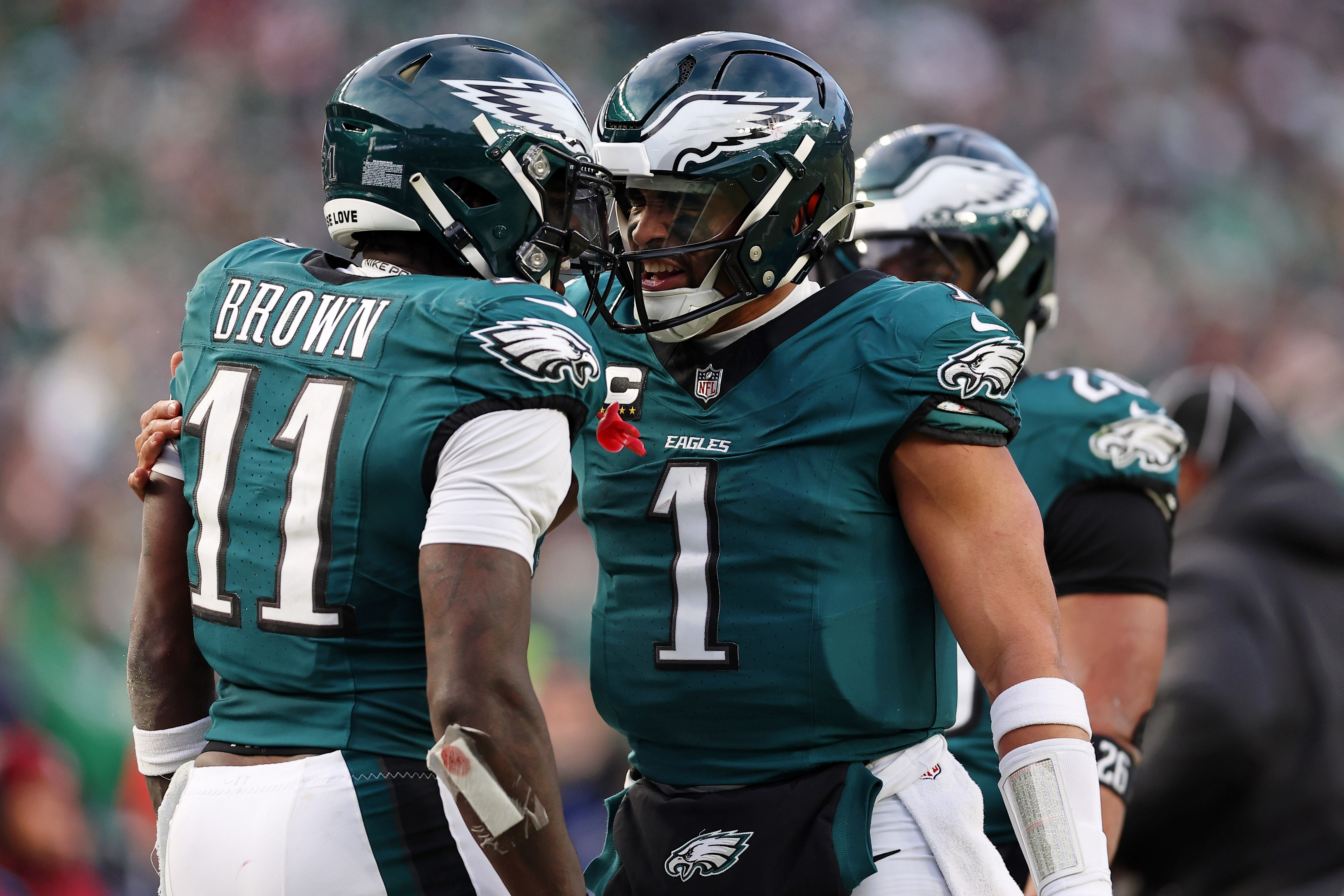 Philadelphia Eagles quarterback Jalen Hurts (1) and wide receiver A.J. Brown (11) celebrate after a touchdown against the Washington Commanders during the first half in the NFC Championship.