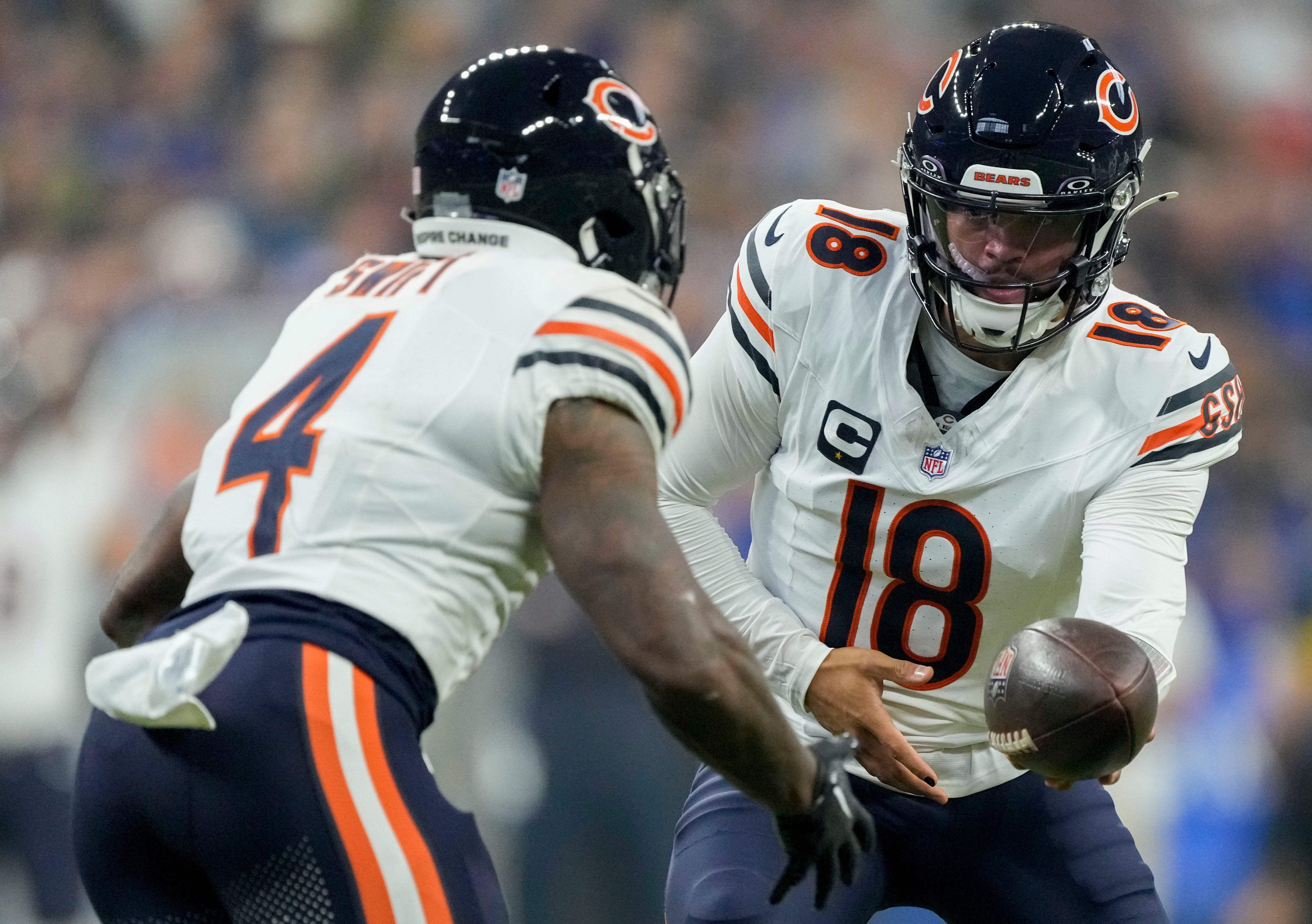 Sep 22, 2024; Indianapolis, Indiana, USA; Chicago Bears quarterback Caleb Williams (18) hands the ball to Chicago Bears running back D'Andre Swift (4) during a game against the Indianapolis Colts at Lucas Oil Stadium.