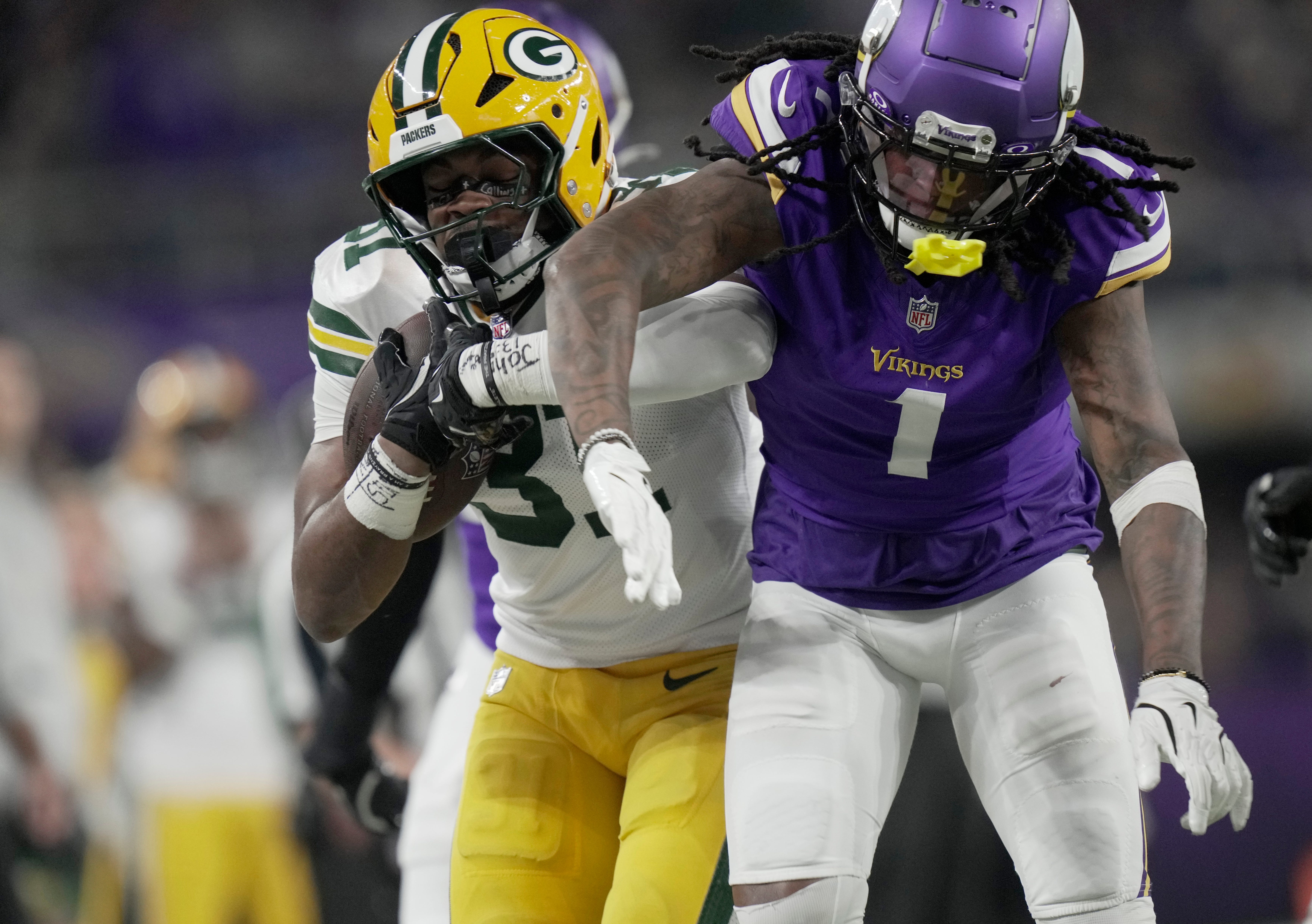Green Bay Packers running back Emanuel Wilson (31) is knocked out bounds by Minnesota Vikings cornerback Shaquill Griffin (1) during the fourth quarter of their game Sunday, December 29, 2024 at U.S. Bank Stadium in Minneapolis, Minnesota. The Minnesota Vikings beat the Green Bay Packers 27-25.