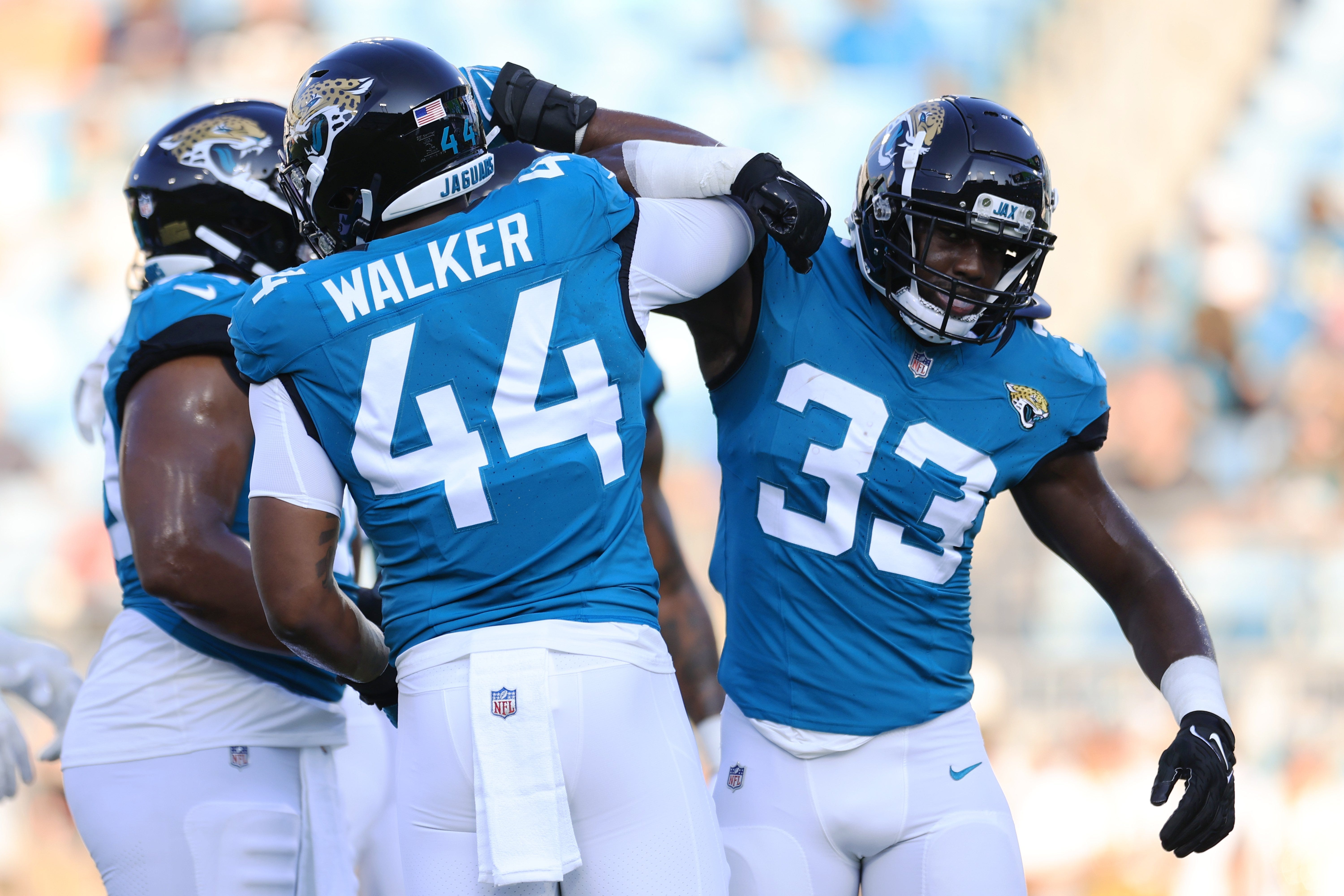 Jacksonville Jaguars linebacker Travon Walker (44) greets linebacker Devin Lloyd (33) before the game of a preseason matchup Saturday, Aug. 26, 2023 at EverBank Stadium in Jacksonville, Fla.