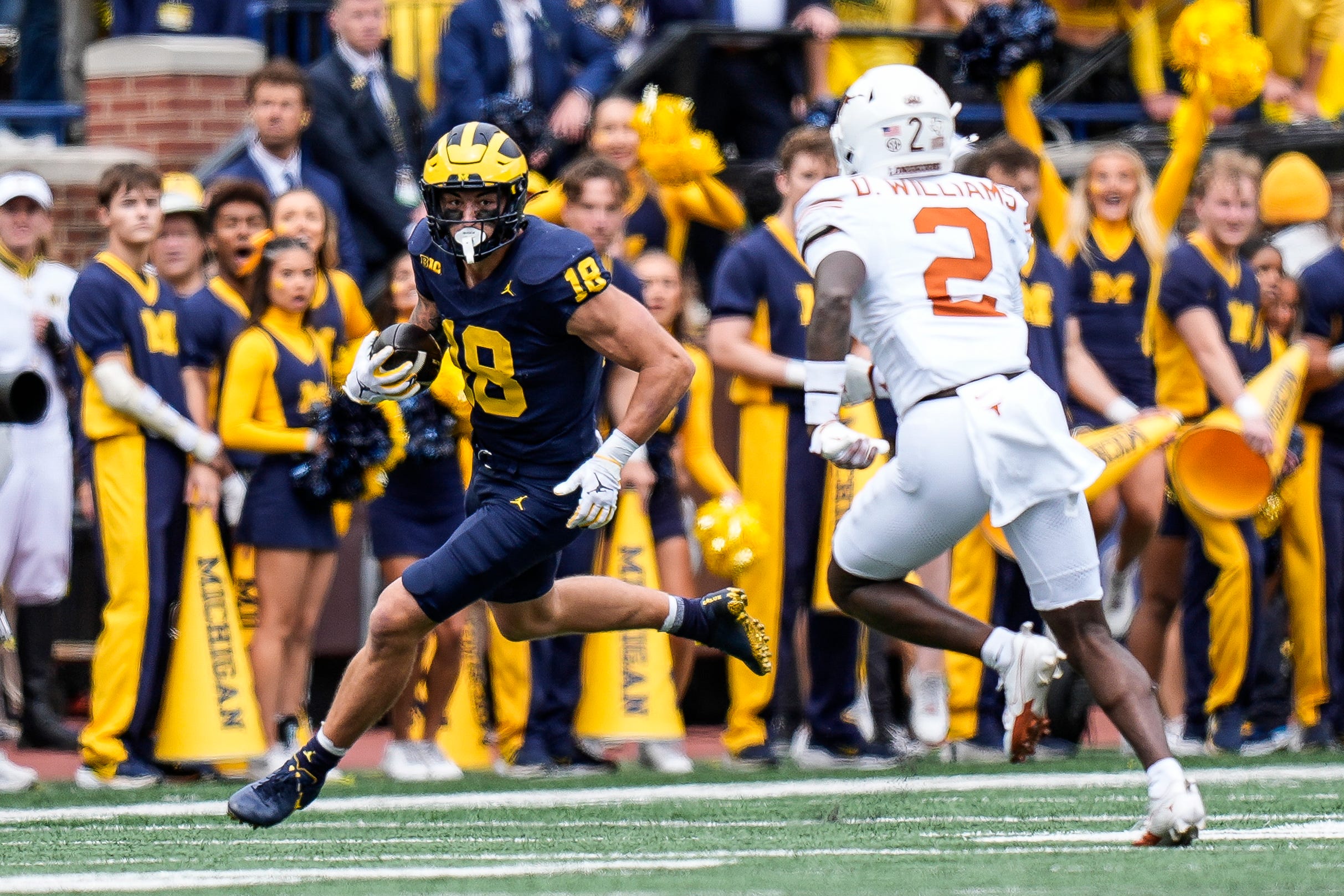 Michigan tight end Colston Loveland (18) makes a catch against Texas defensive back Derek Williams Jr. (2) during the first half at Michigan Stadium in Ann Arbor on Saturday, September 7, 2024.