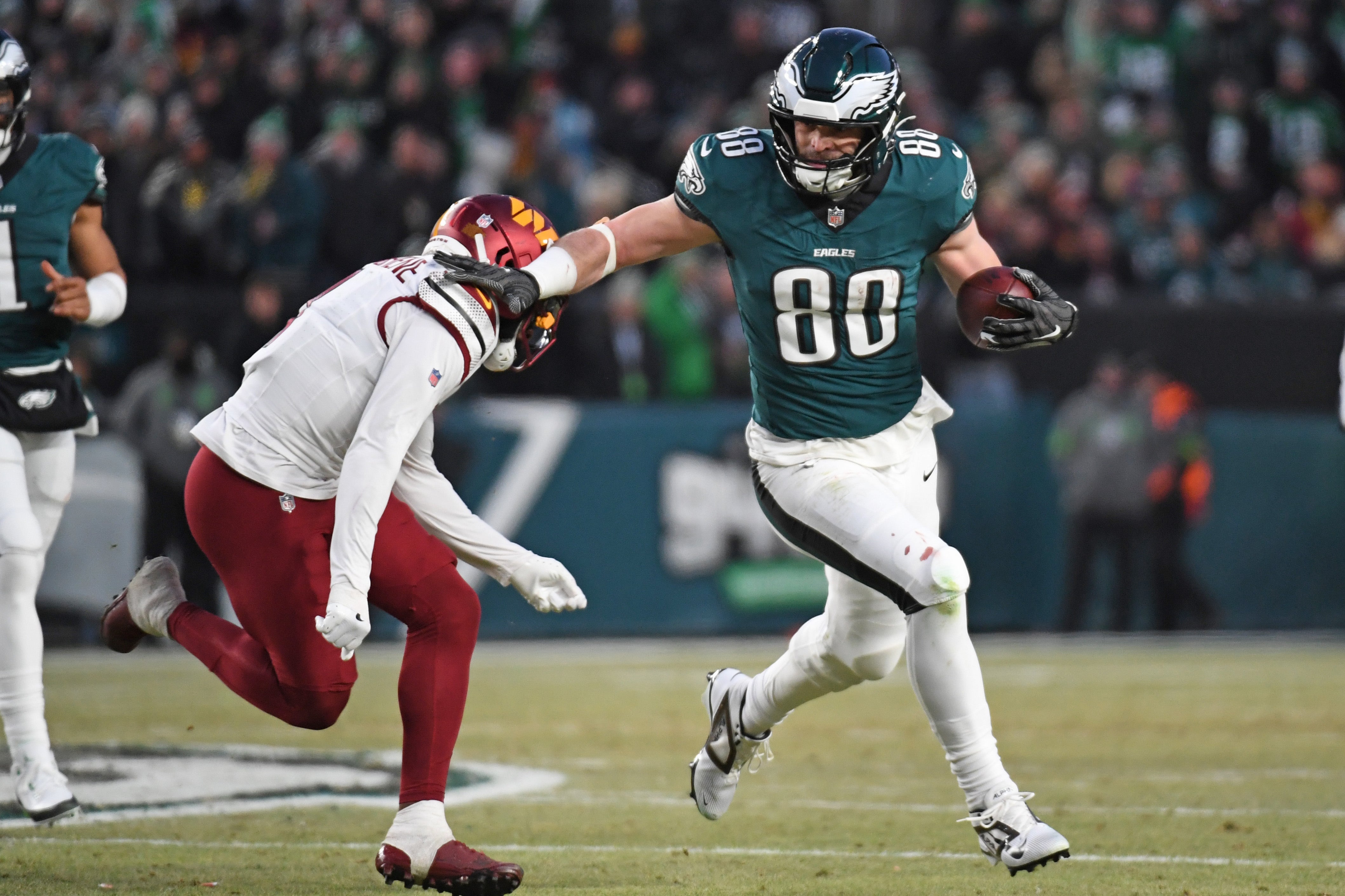 Philadelphia Eagles tight end Dallas Goedert (88) tries to get past Washington Commanders cornerback Mike Sainristil (0) in the NFC Championship game at Lincoln Financial Field.