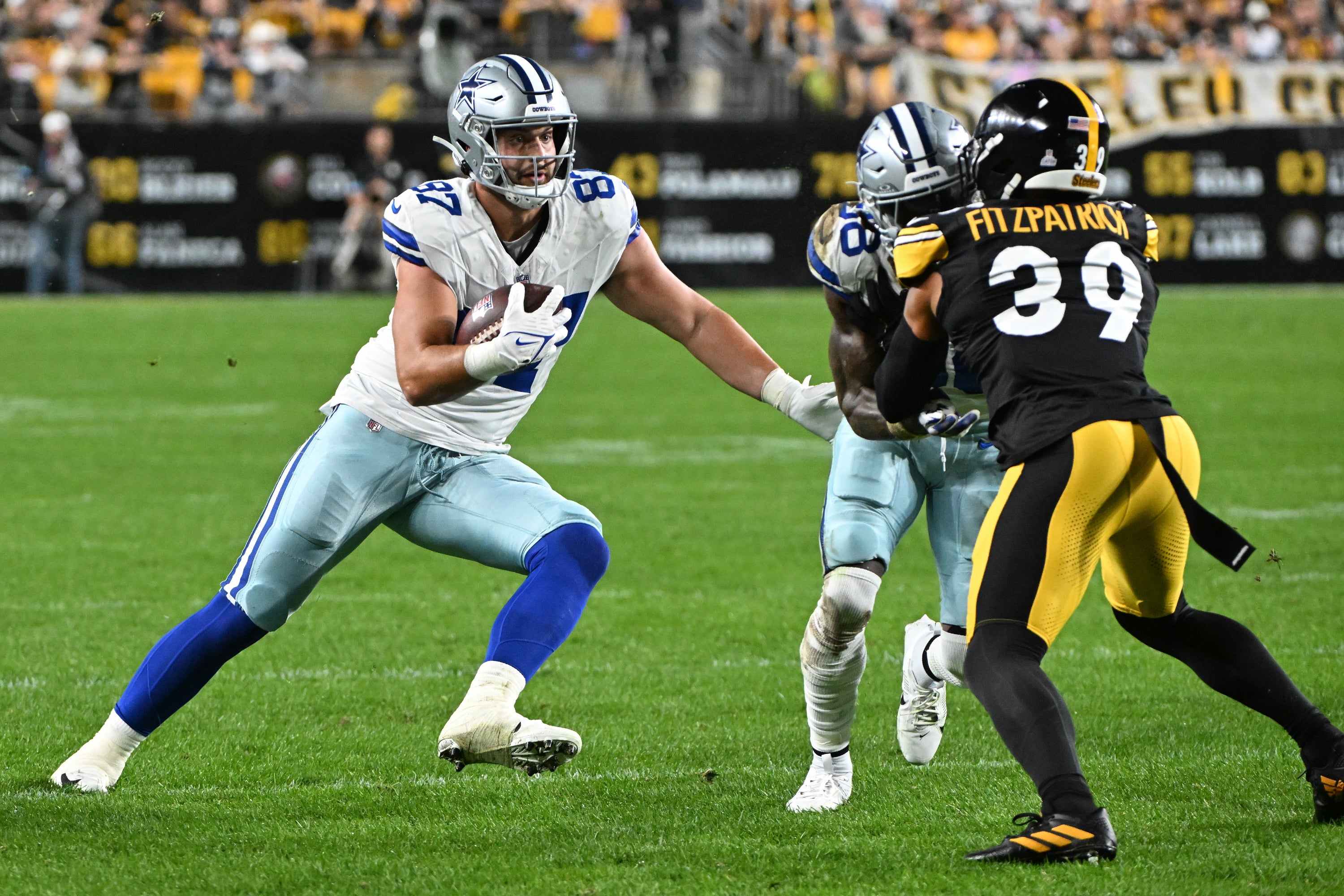 Dallas Cowboys tight end Jake Ferguson (87) eludes Pittsburgh Steelers safety Minkah Fitzpatrick (39) during the second quarter at Acrisure Stadium.