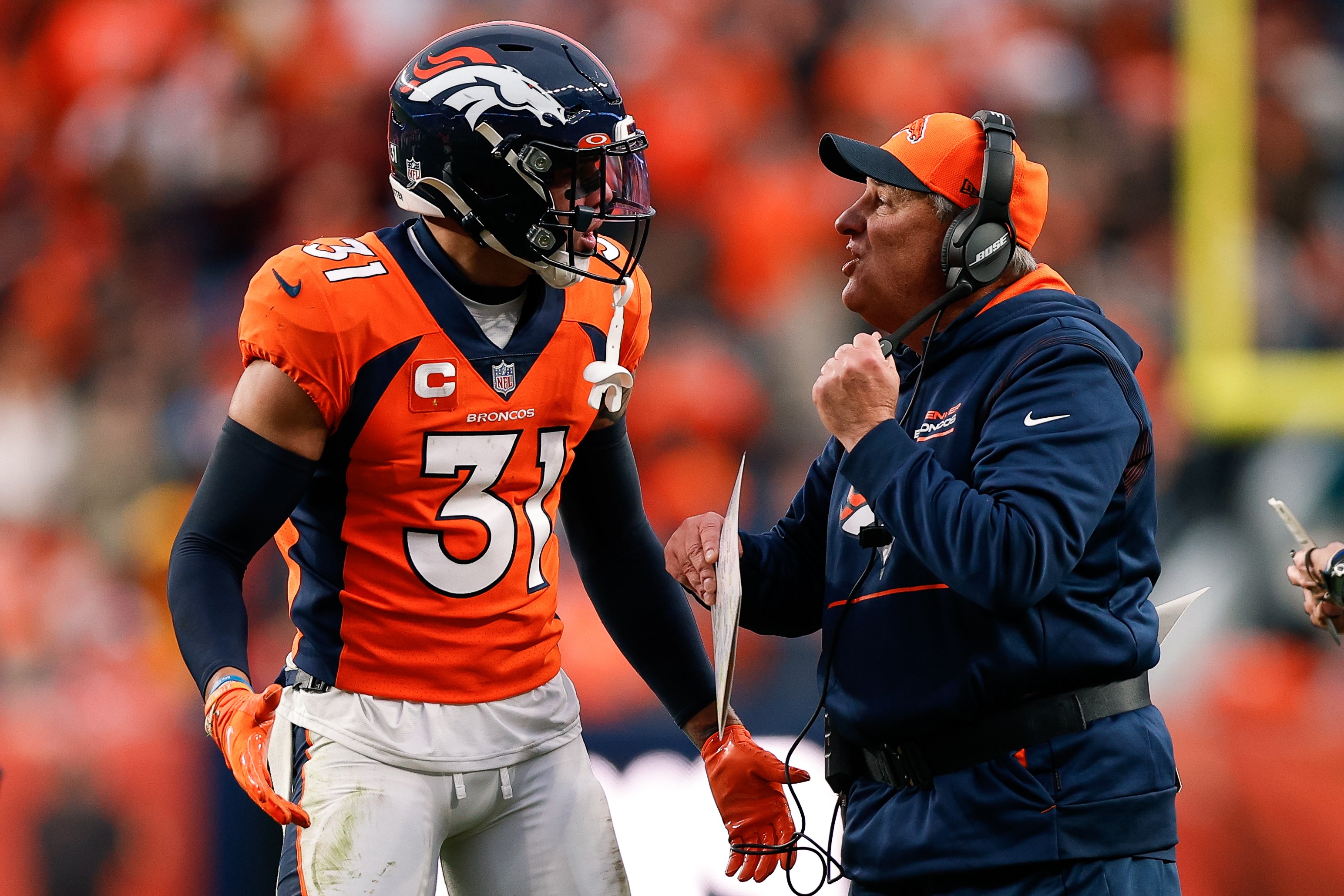 Denver Broncos head coach Vic Fangio talks with safety Justin Simmons (31) in the fourth quarter against the Washington Football Team at Empower Field at Mile High.