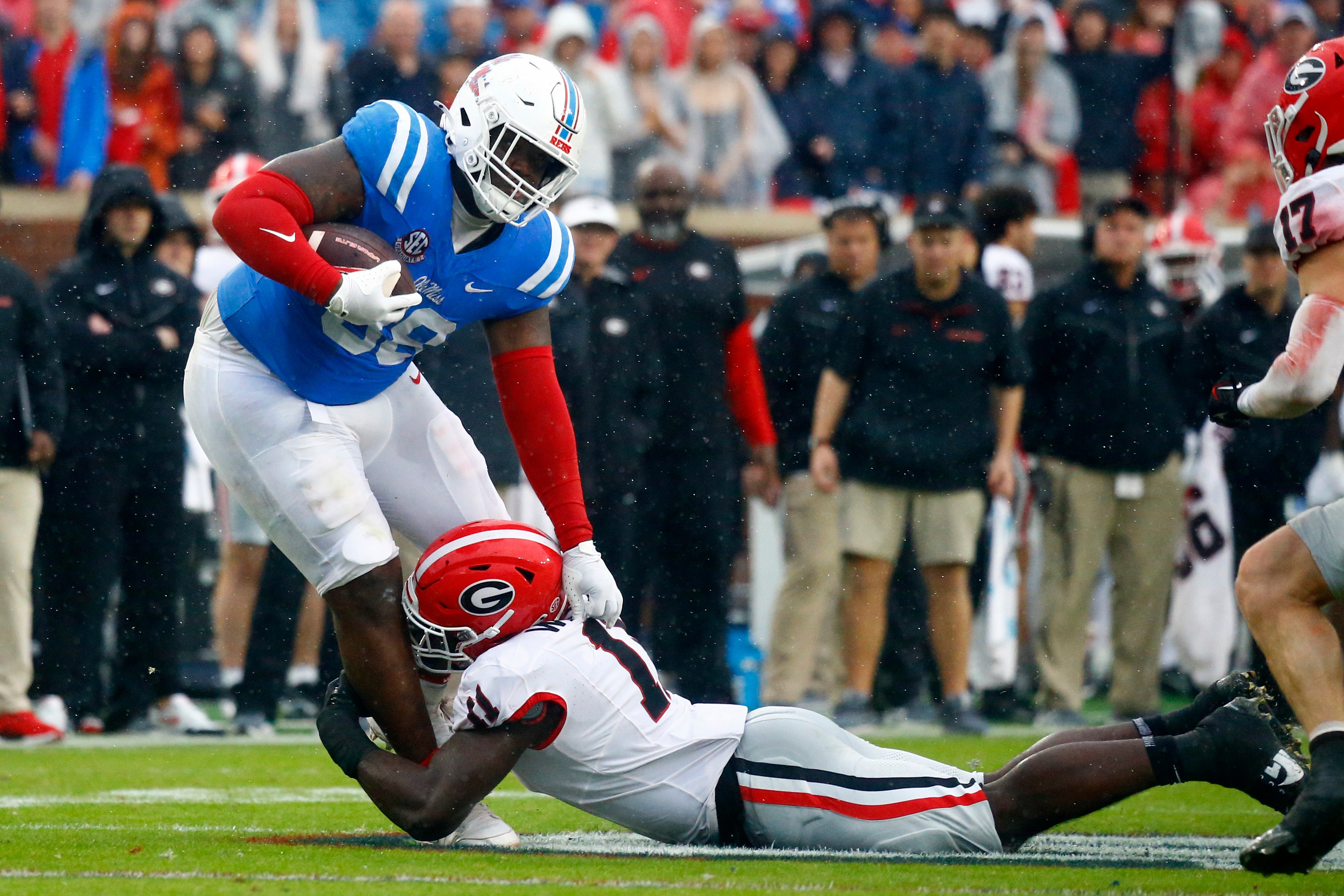 Nov 9, 2024; Oxford, Mississippi, USA; Mississippi Rebels defensive JJ Pegues (38) runs the ball as Georgia Bulldogs linebacker Jalon Walker (11) makes the tackle during the first half at Vaught-Hemingway Stadium.