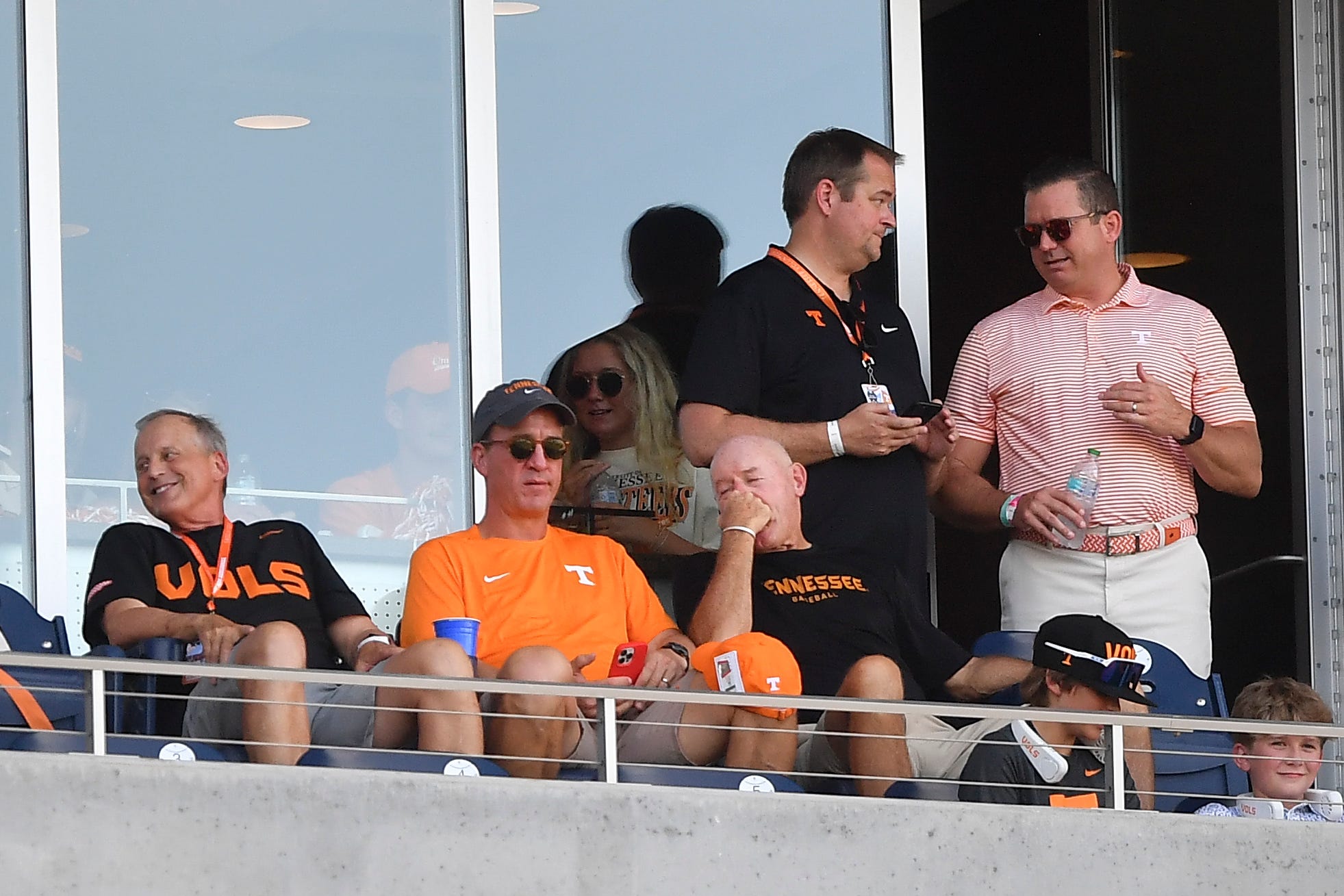 From left, Tennessee men’s basketball coach Rick Barnes, Peyton Manning, Tennessee’s football coach Josh Heupel, and Tennessee’s athletic director Danny White, in the stands during game three of the NCAA College World Series finals between Tennessee and Texas A&M at Charles Schwab Field in Omaha, Neb., on Monday, June 24, 2024.