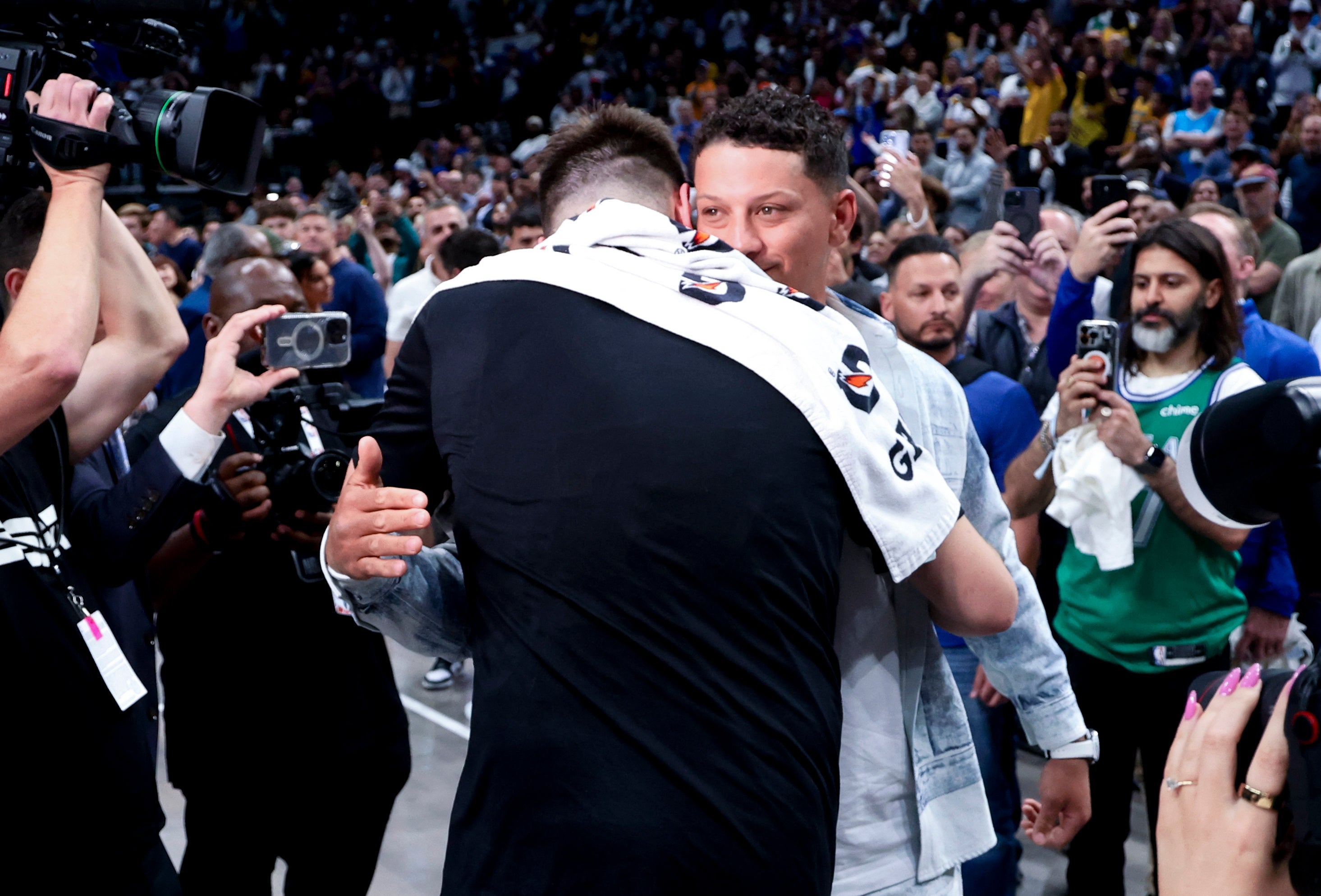 Apr 9, 2025; Dallas, Texas, USA; Los Angeles Lakers guard Luka Doncic (77) hugs Kansas City Chiefs quarterback Patrick Mahomes after the game against the Dallas Mavericks at American Airlines Center.