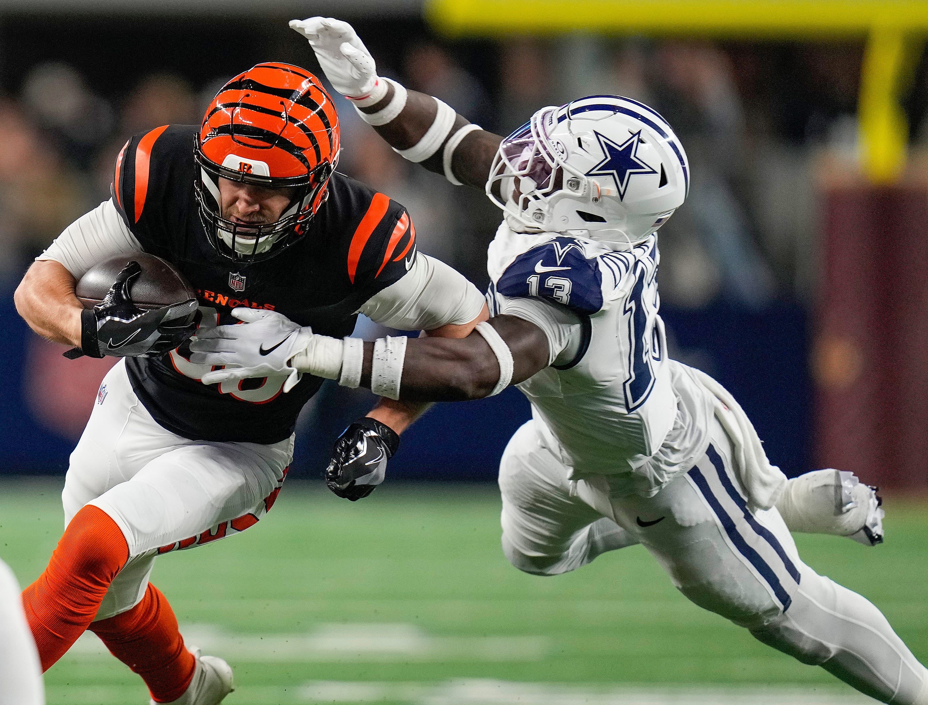 Cincinnati Bengals tight end Mike Gesicki (88) tries to break free from Dallas Cowboys linebacker DeMarvion Overshown (13) during the first half Monday Night Football at AT&T Stadium in Arlington, Texas on Monday, December 9, 2024.