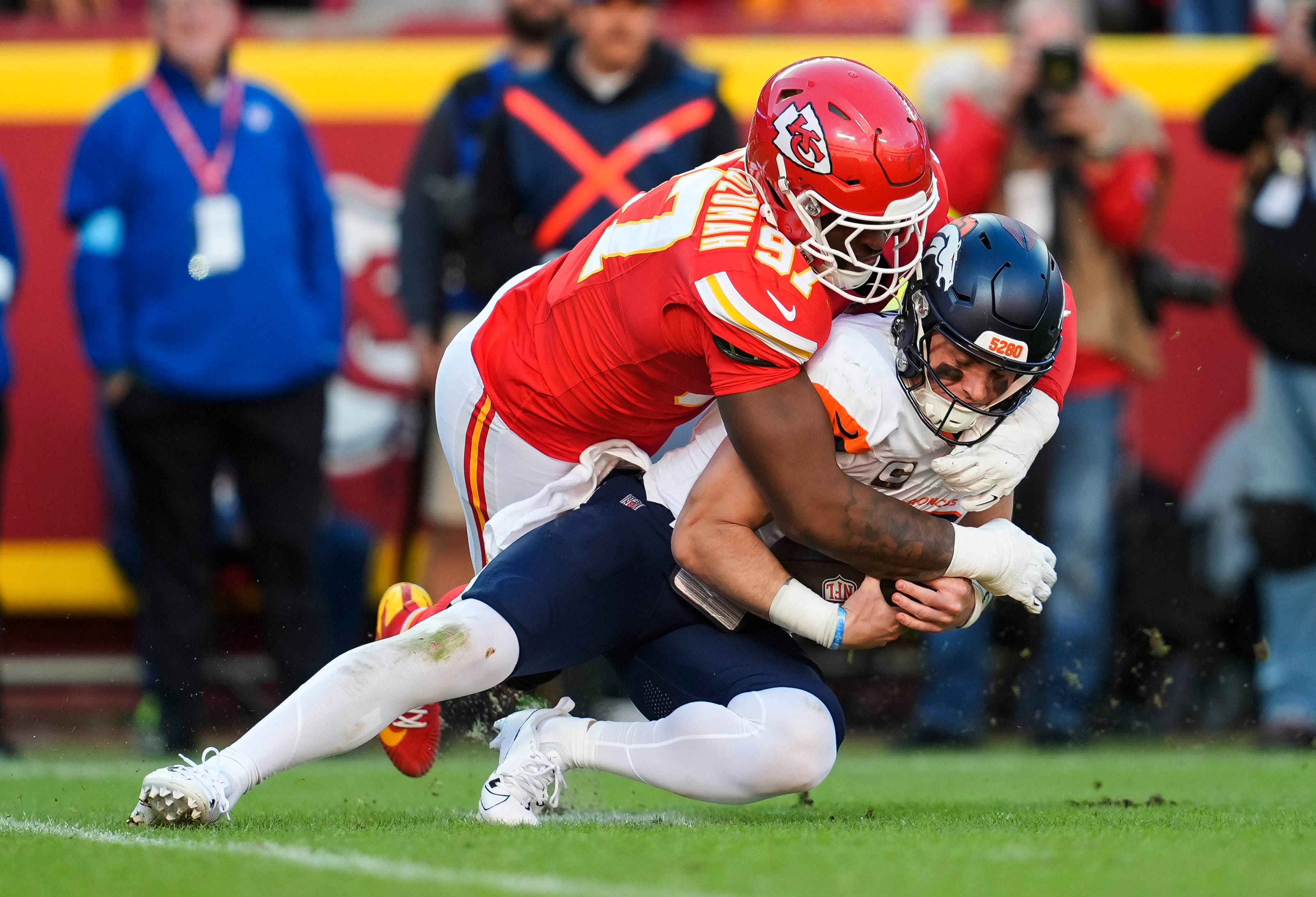 Denver Broncos quarterback Bo Nix (10) is sacked by Kansas City Chiefs defensive end Felix Anudike-Uzomah (97)