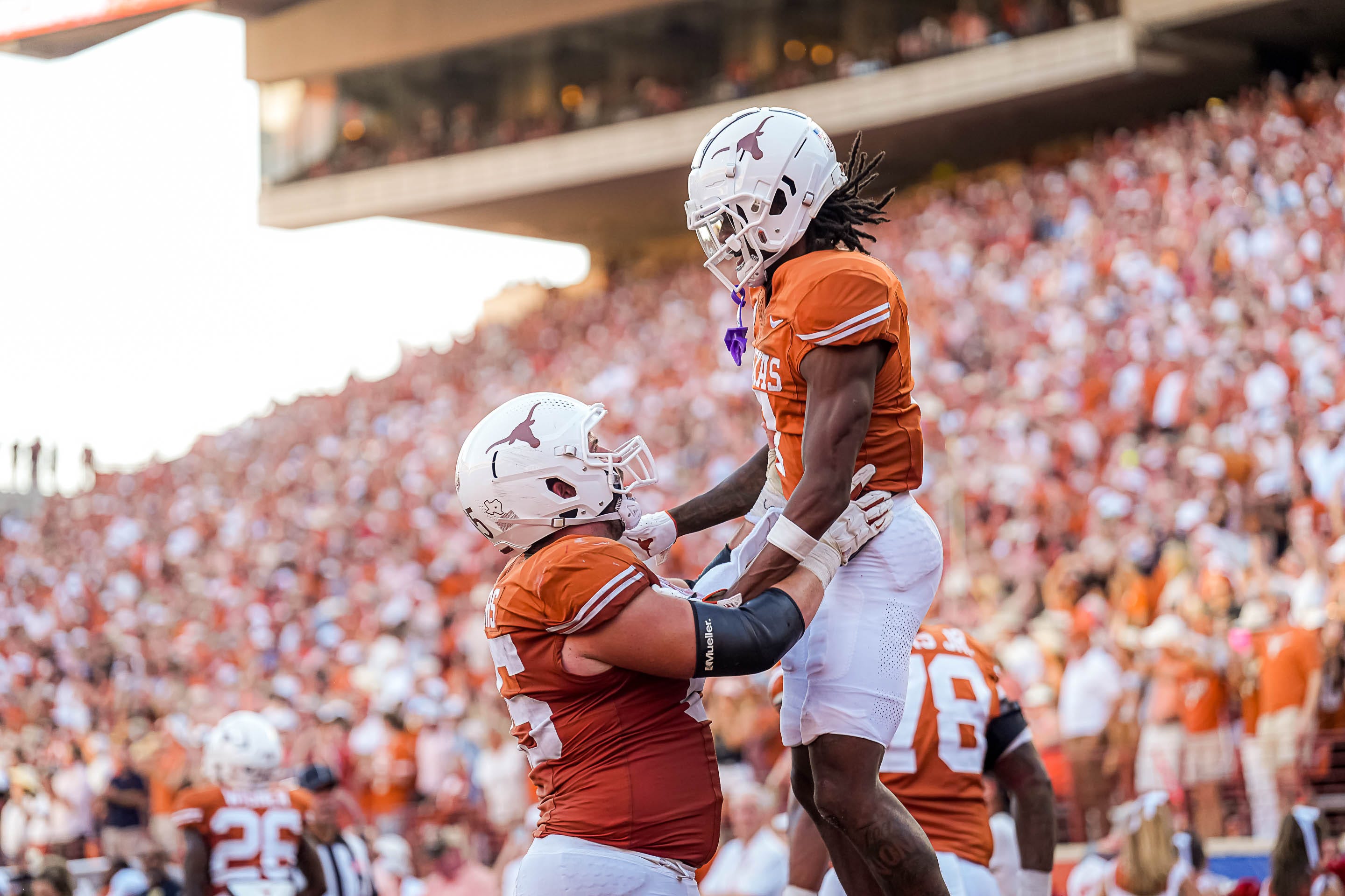 Texas Longhorns center Jake Majors (65) celebrates a touchdown my receiver Isaiah Bond (7) during the game against Mississippi State at Darrell K Royal-Texas Memorial Stadium in Austin