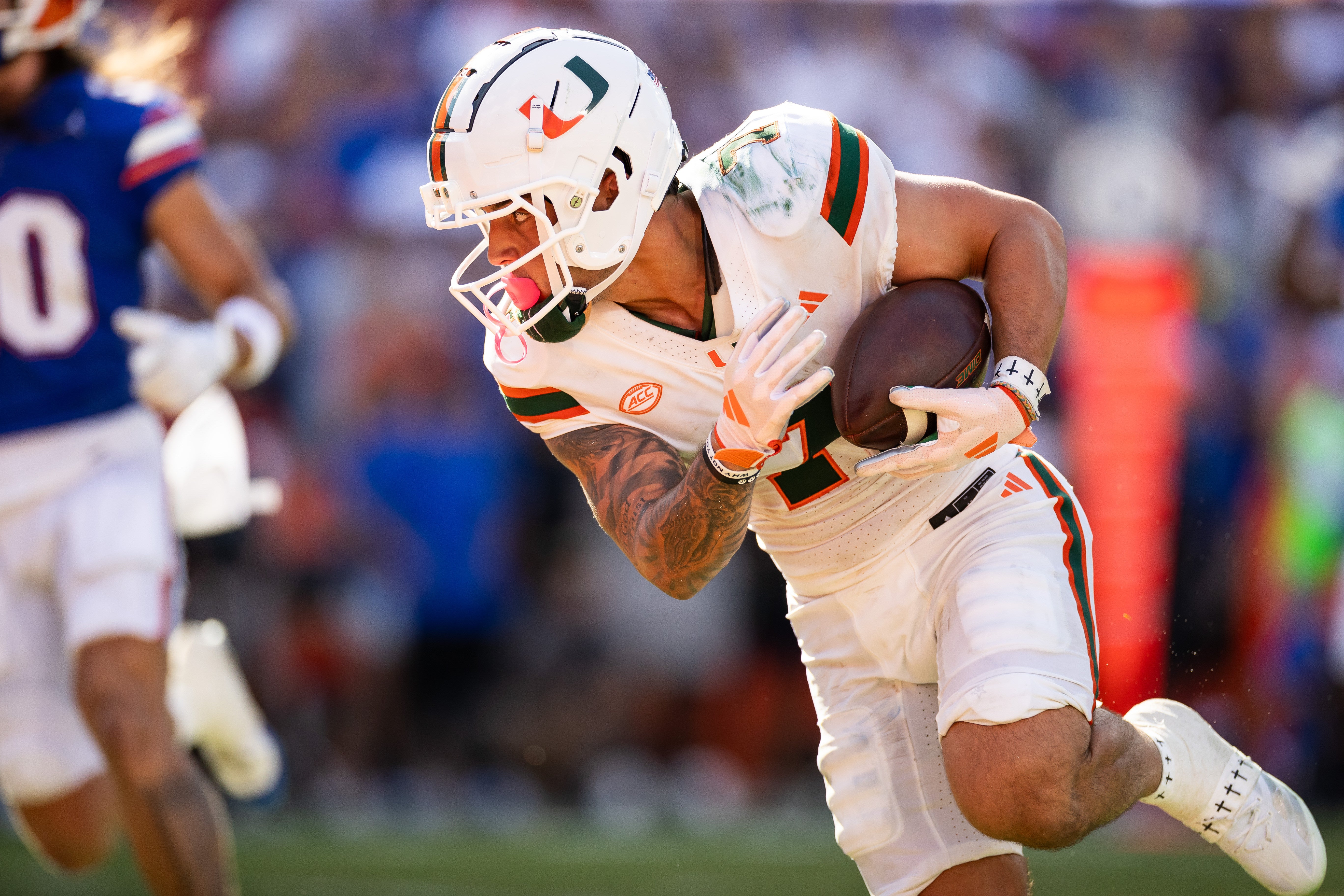 Aug 31, 2024; Gainesville, Florida, USA; Miami Hurricanes wide receiver Xavier Restrepo (7) catches a pass and runs for a touchdown against the Florida Gators during the first half at Ben Hill Griffin Stadium.