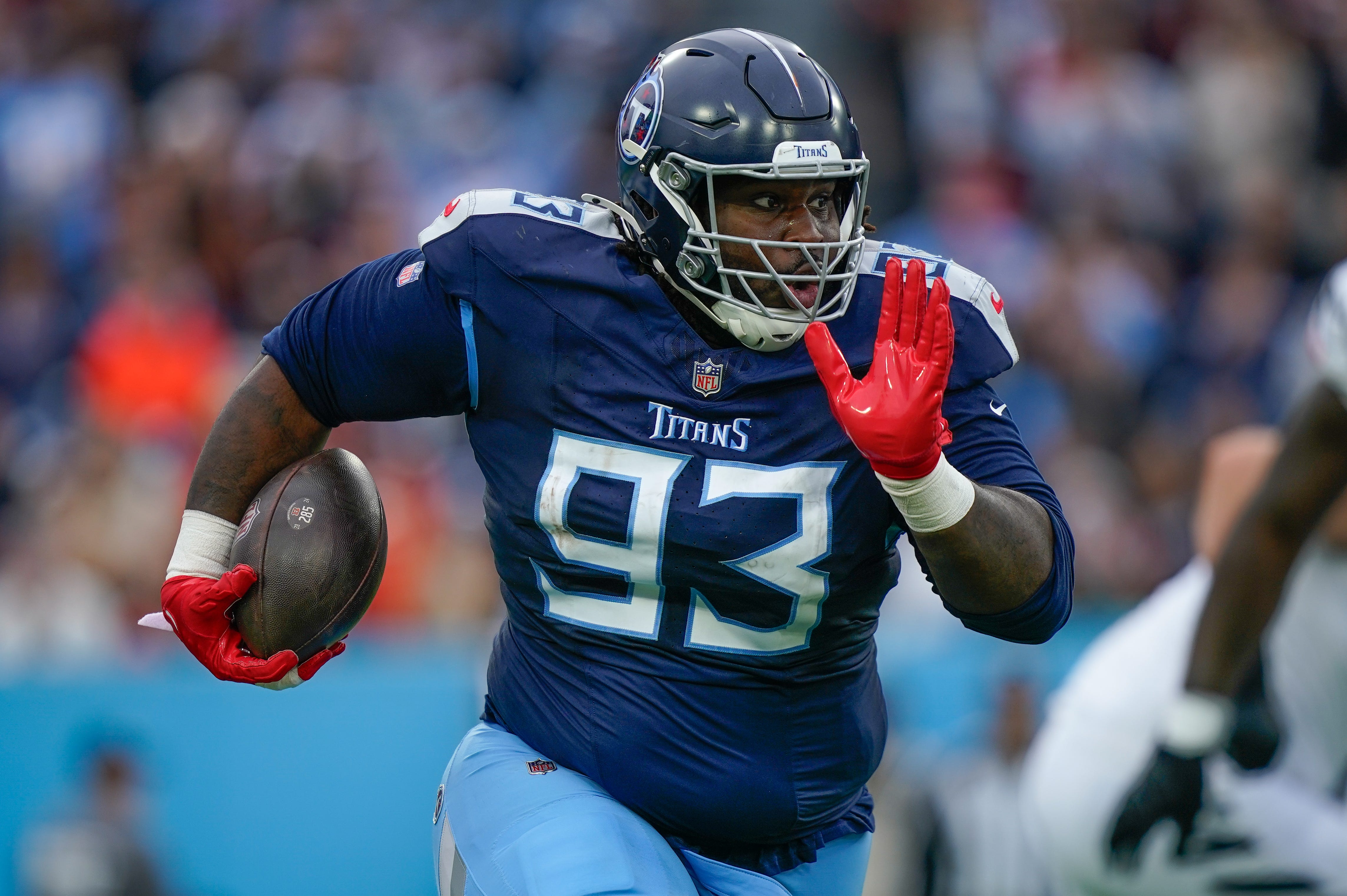 Tennessee Titans defensive tackle T'Vondre Sweat (93) returns the ball after stripping it from Cincinnati Bengals quarterback Joe Burrow (9) during the second quarter at Nissan Stadium in Nashville, T... Denny Simmons / The Tennessean-USA TODAY NETWORK via Imagn Images