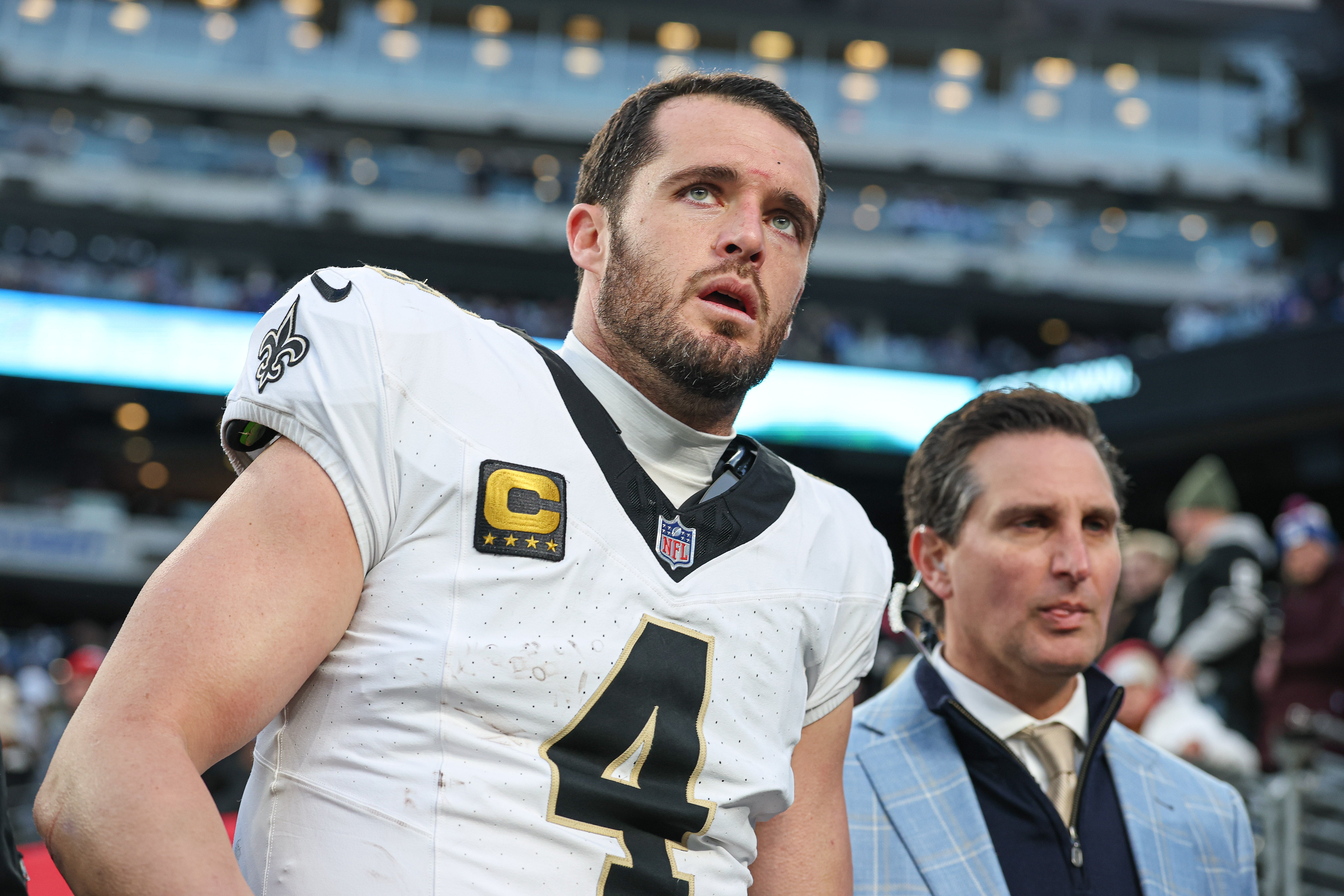 Dec 8, 2024; East Rutherford, New Jersey, USA; New Orleans Saints quarterback Derek Carr (4) walks off the field after field after an injury during the fourth quarter at MetLife Stadium.