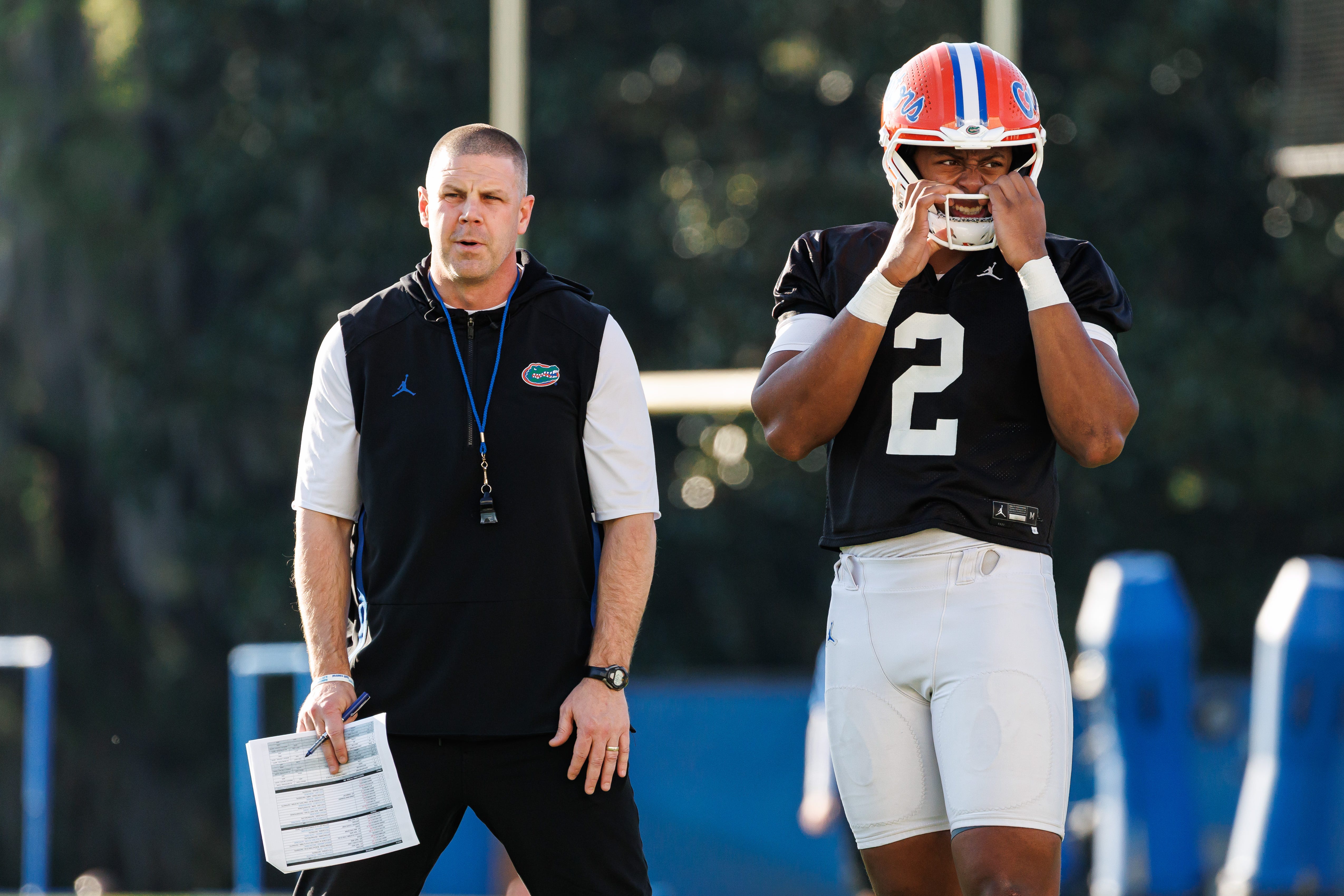 Florida Gators head coach Billy Napier and Florida Gators quarterback DJ Lagway (2) watch during spring football practice at Heavener Football Complex at the University of Florida in Gainesville, FL on Thursday, March 6, 2025.