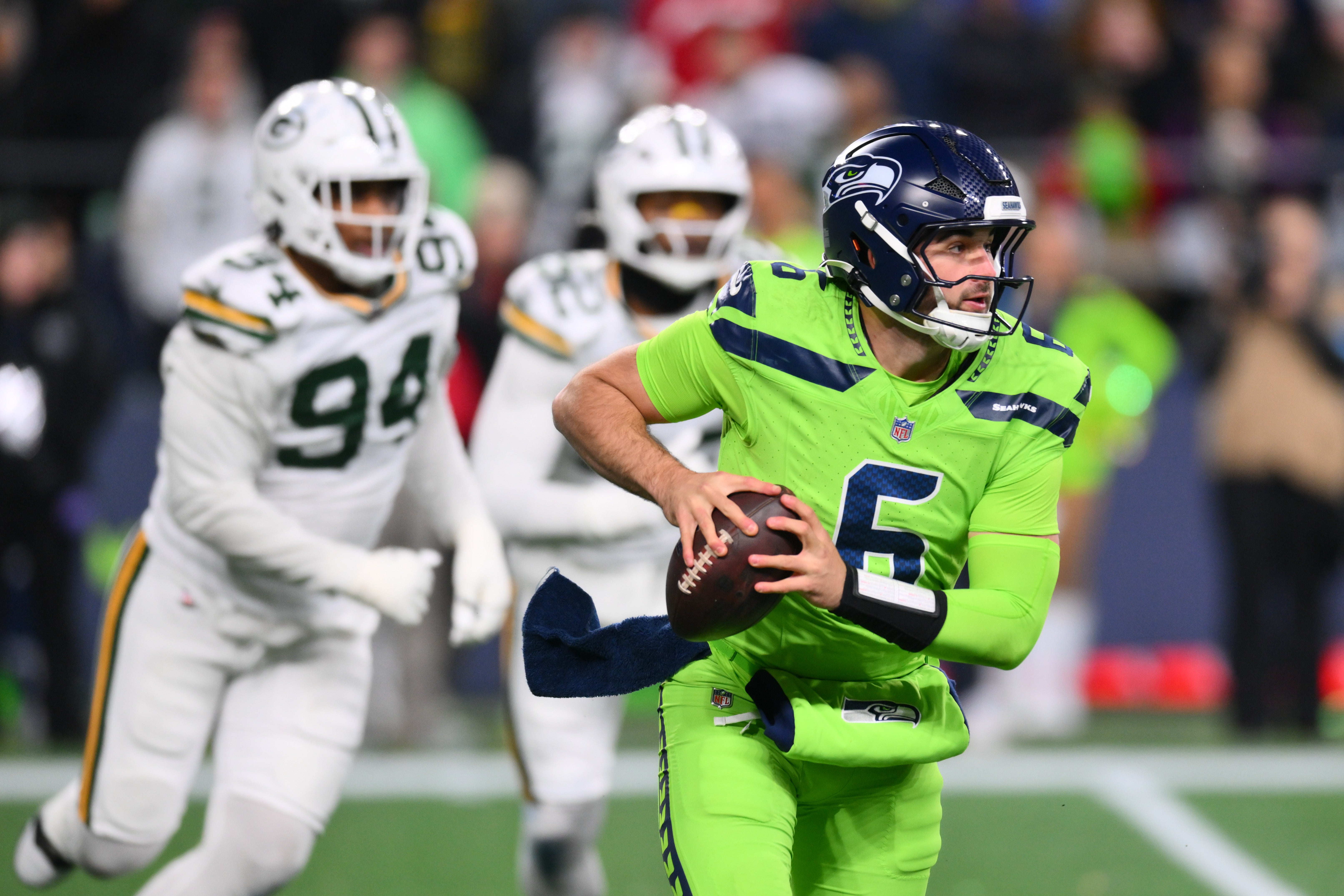 Dec 15, 2024; Seattle, Washington, USA; Seattle Seahawks quarterback Sam Howell (6) carries the ball against the Green Bay Packers during the second half at Lumen Field.