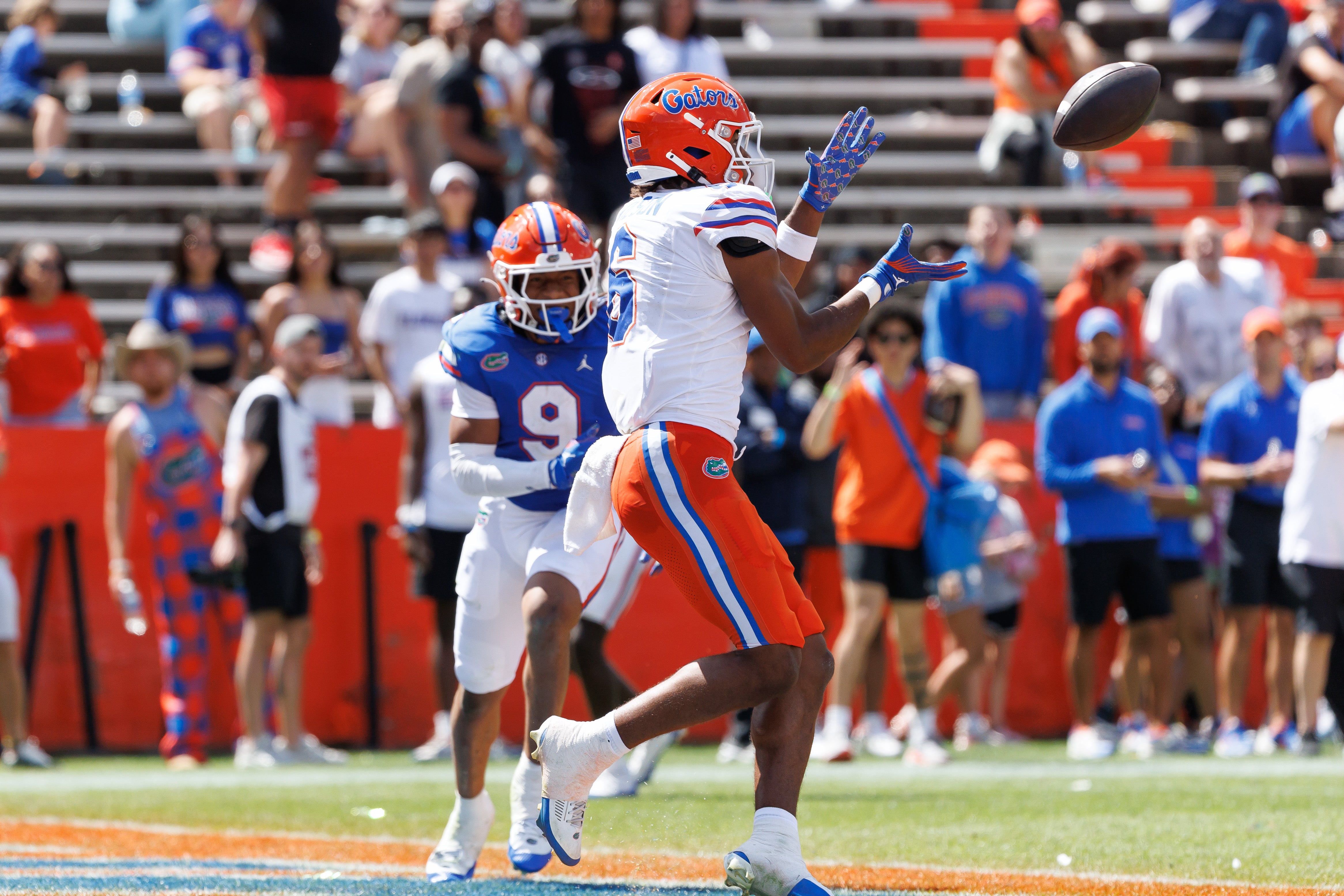 Apr 12, 2025; Gainesville, FL, USA; Florida Gators wide receiver Dallas Wilson (6) catches a pass for a touchdown over Florida Gators defensive back Drake Stubbs (9) during the second half at Ben Hill Griffin Stadium.
