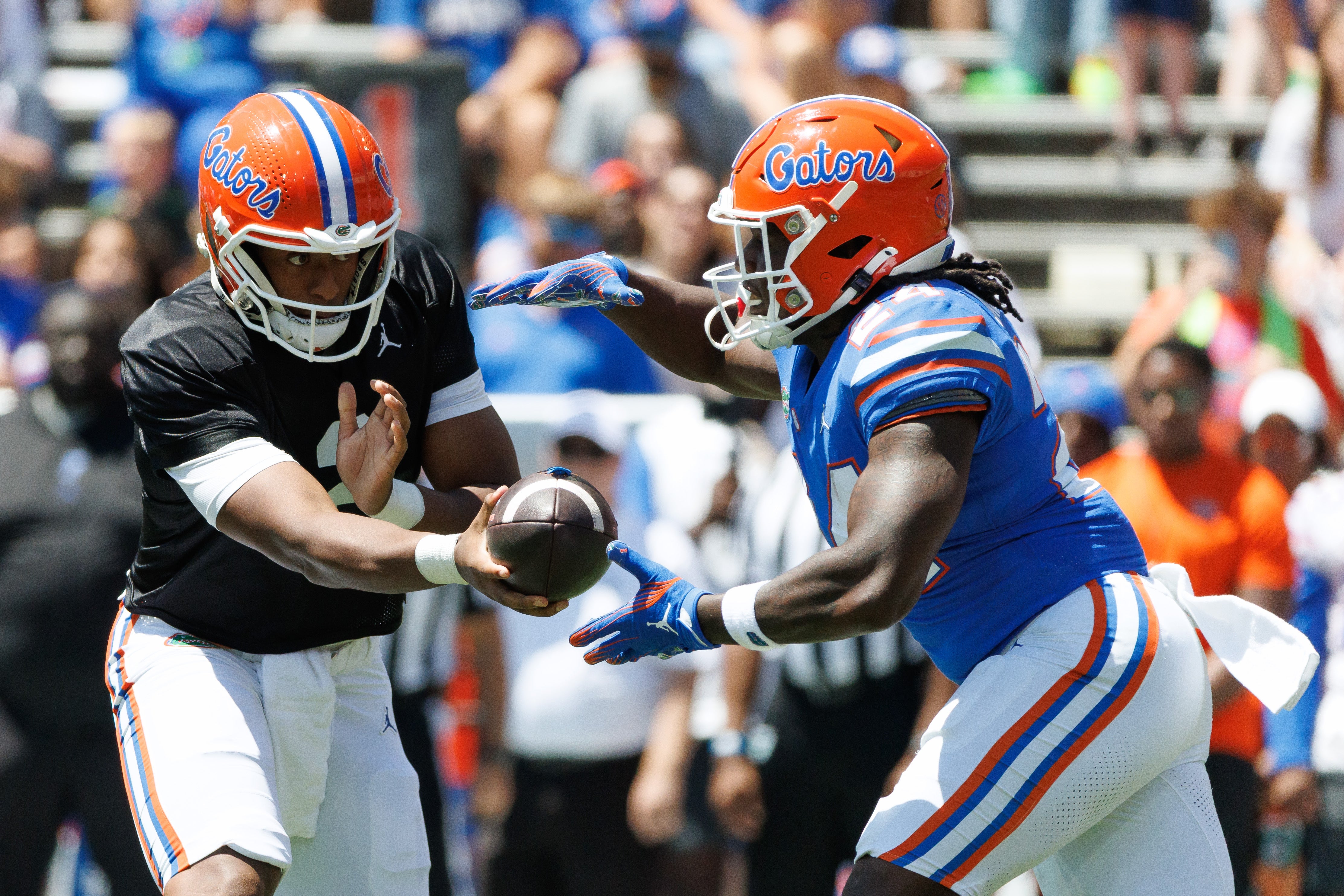 Apr 12, 2025; Gainesville, FL, USA; Florida Gators quarterback DJ Lagway (2) hands the ball to Florida Gators running back Ja'Kobi Jackson (24) during the first half at Ben Hill Griffin Stadium.