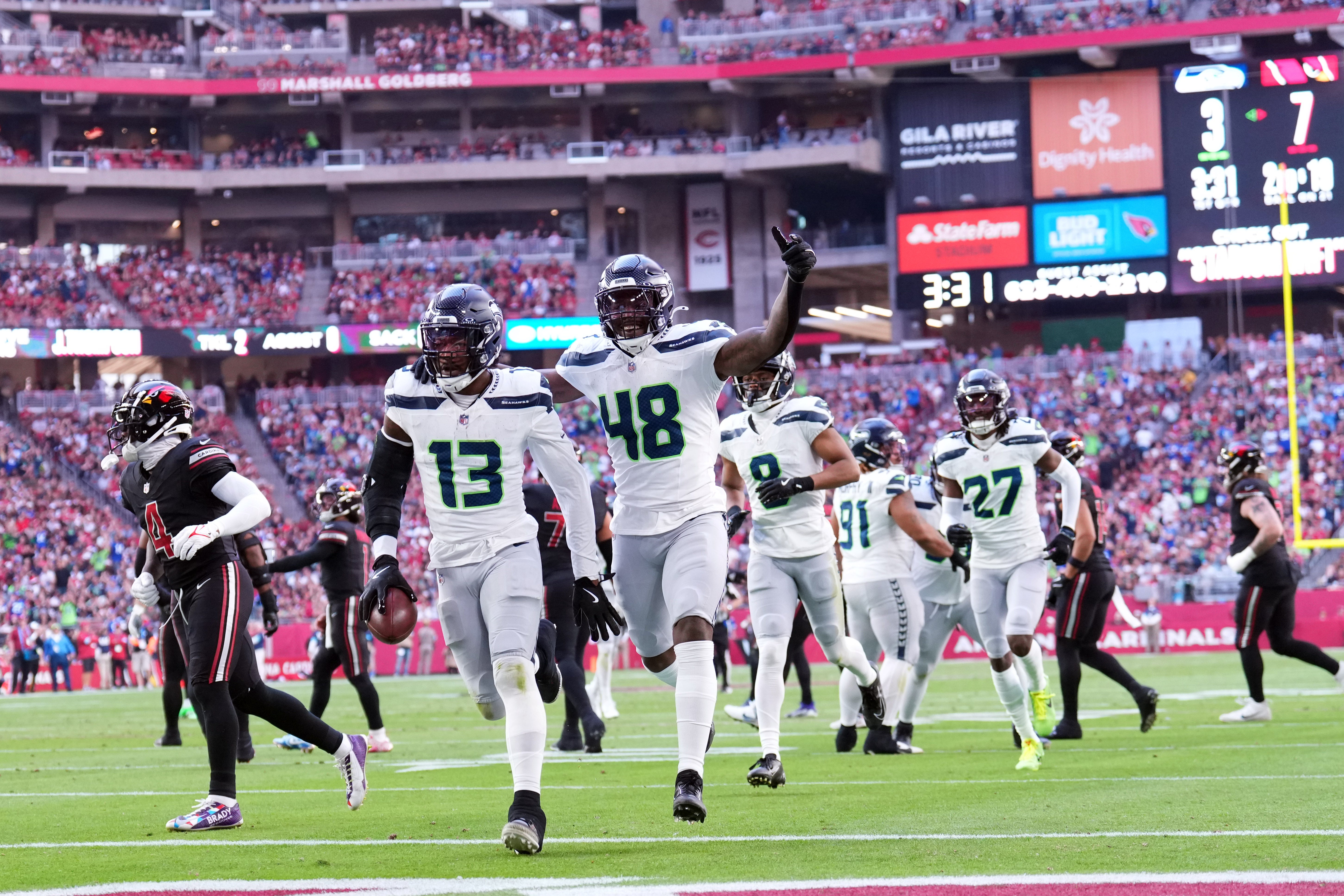 Dec 8, 2024; Glendale, Arizona, USA; Seattle Seahawks linebacker Ernest Jones IV (13) celebrates an interception against the Arizona Cardinals during the first half at State Farm Stadium.