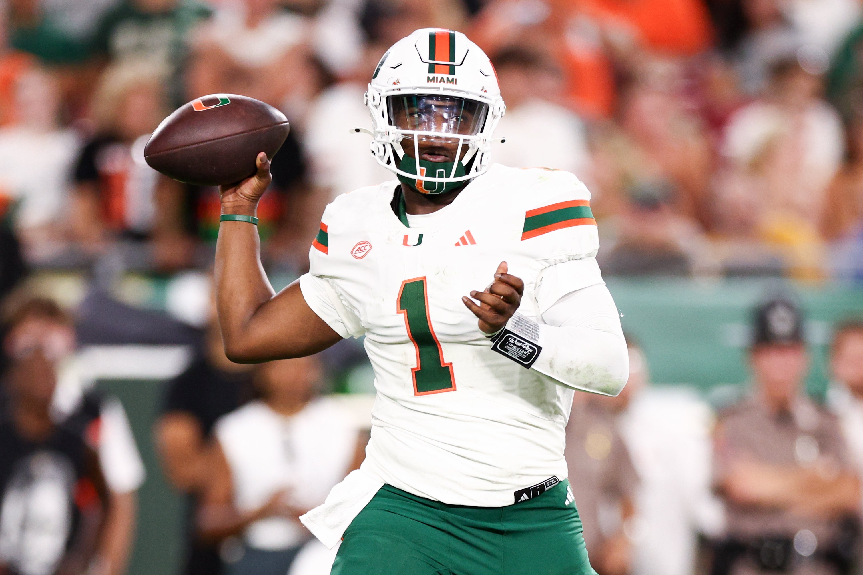 Sep 21, 2024; Tampa, Florida, USA; Miami Hurricanes quarterback Cam Ward (1) drops back to pass against the South Florida Bulls in the second quarter at Raymond James Stadium. Mandatory Credit: Nathan Ray Seebeck-Imagn Images