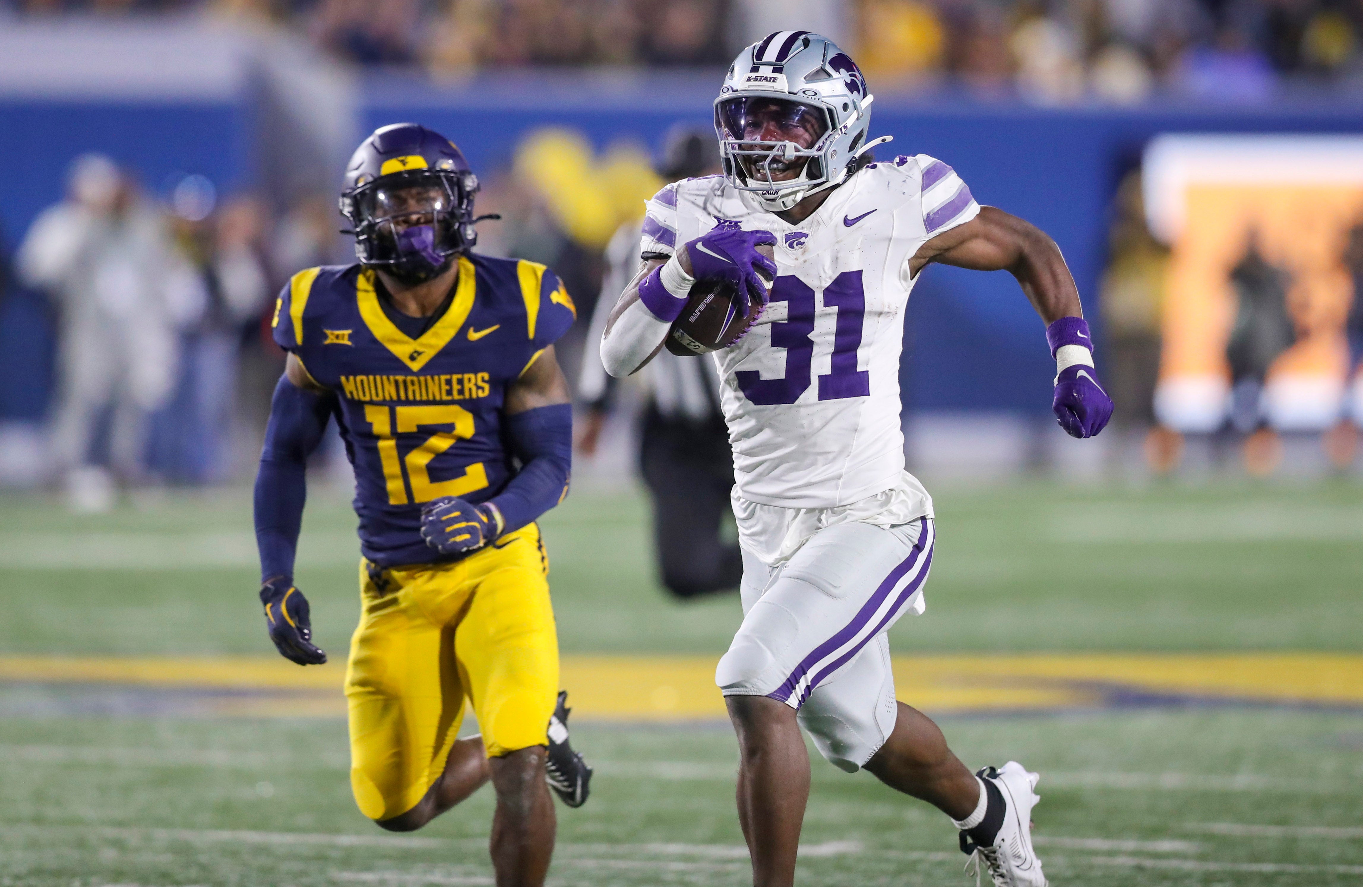 Oct 19, 2024; Morgantown, West Virginia, USA; Kansas State Wildcats running back DJ Giddens (31) runs after a catch during the third quarter against the West Virginia Mountaineers at Mountaineer Field at Milan Puskar Stadium.