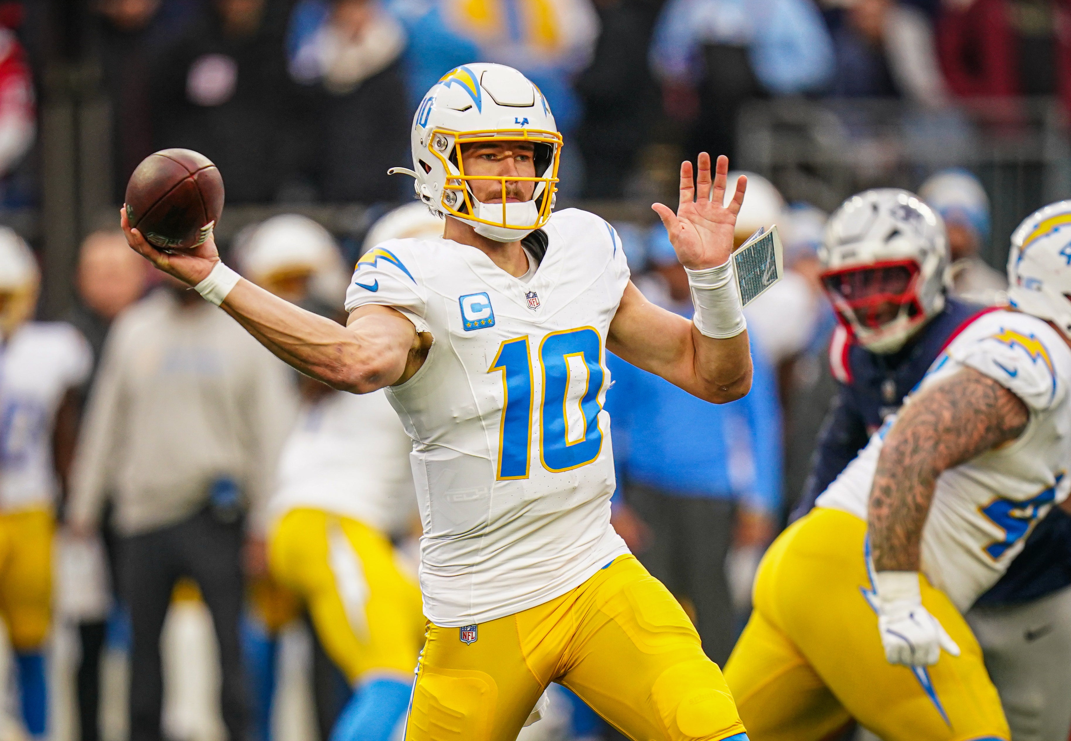 Dec 28, 2024; Foxborough, Massachusetts, USA; Los Angeles Chargers quarterback Justin Herbert (10) passes the ball against the New England Patriots in the third quarter at Gillette Stadium.