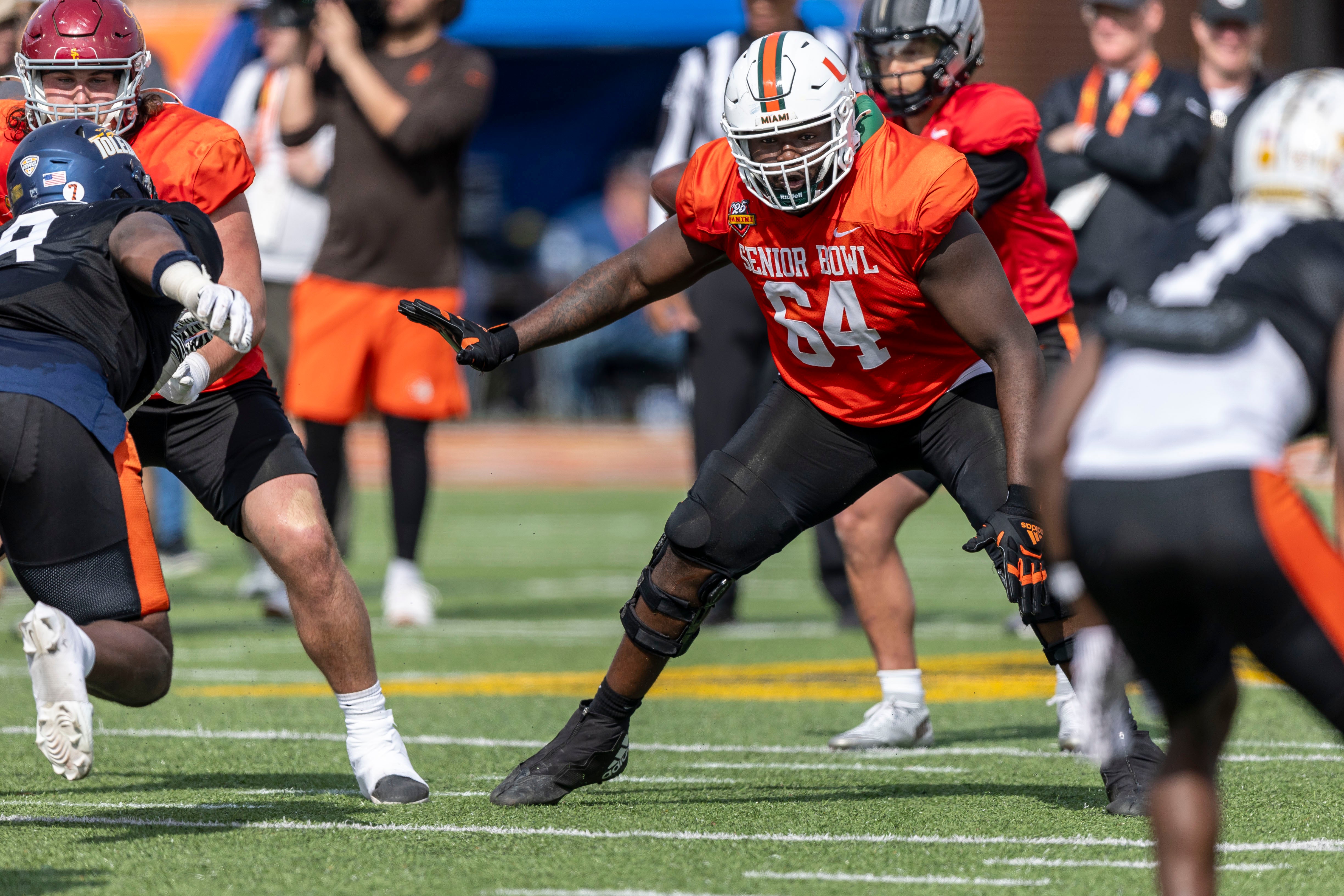 Jan 29, 2025; Mobile, AL, USA; National team offensive lineman Jalen Rivers of Miami (64) looks to block during Senior Bowl practice for the National team at Hancock Whitney Stadium.
