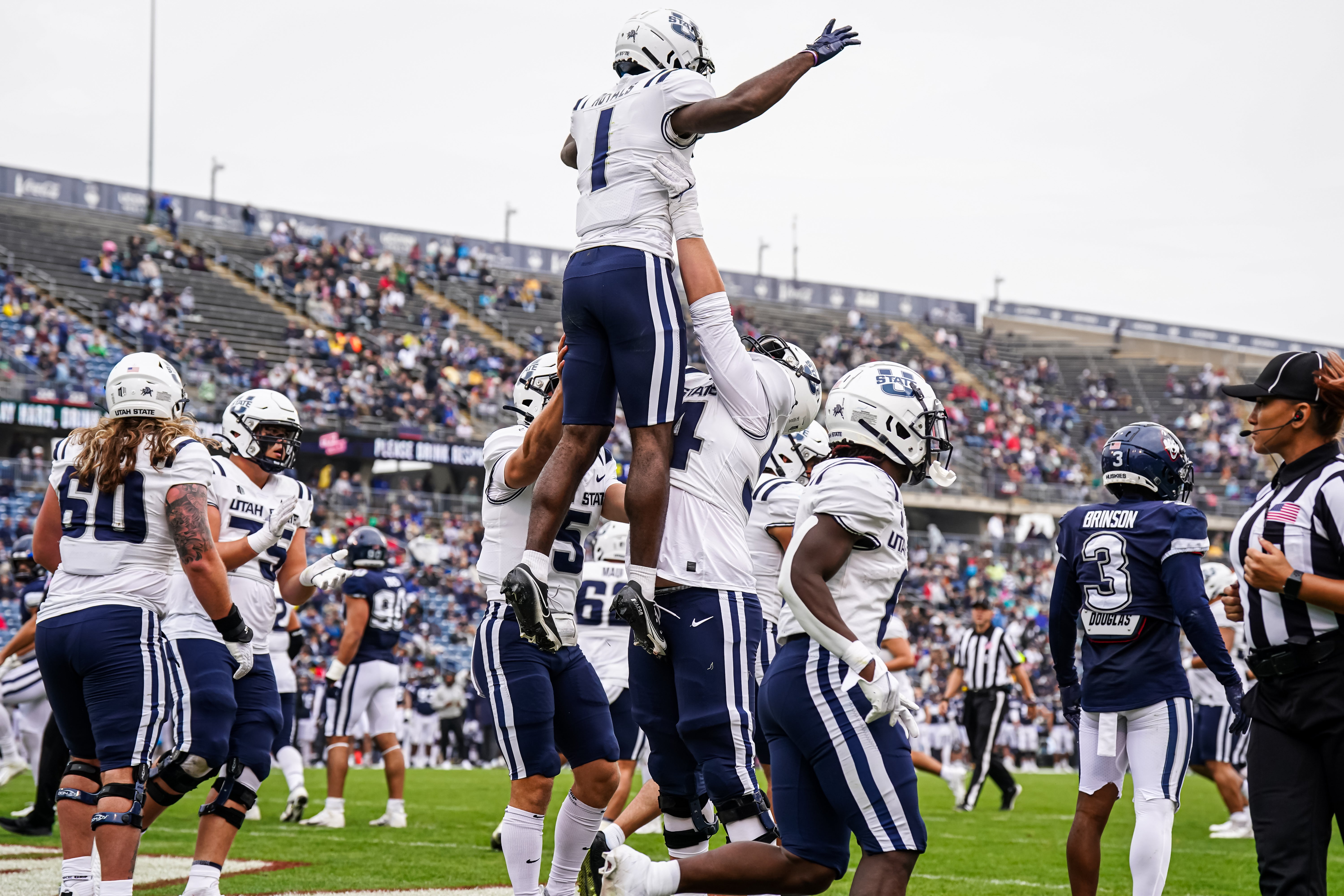 Sep 30, 2023; East Hartford, Connecticut, USA; Utah State Aggies wide receiver Jalen Royals (1) is congratulated after his touchdown catch against the UConn Huskies in the second half at Rentschler Field at Pratt & Whitney Stadium. Mandatory Credit: David Butler II-Imagn Images