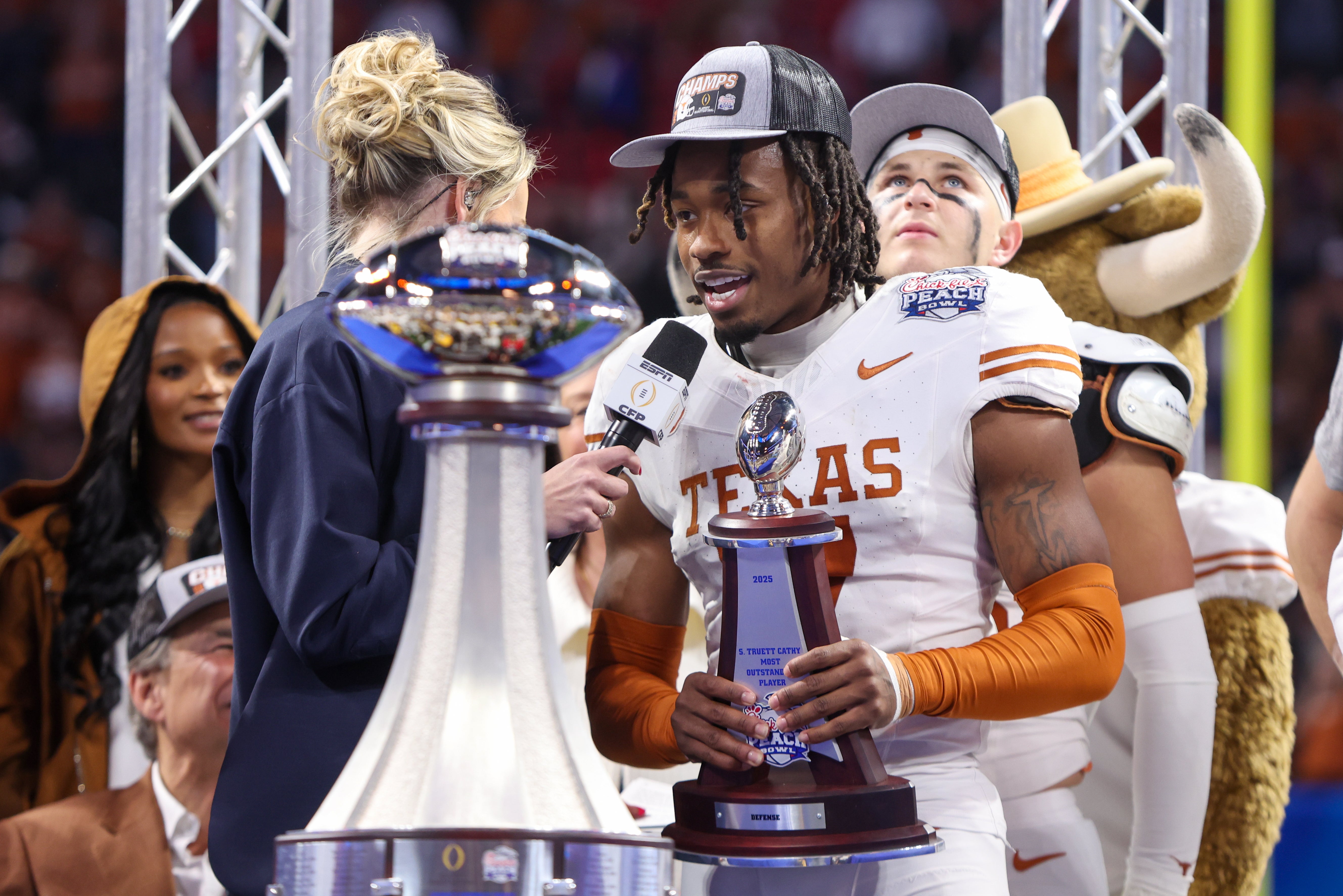 Texas Longhorns defensive back Jahdae Barron (7) receives the most outstanding player award after a victory over the Arizona State Sun Devils in the Peach Bowl at Mercedes-Benz Stadium.