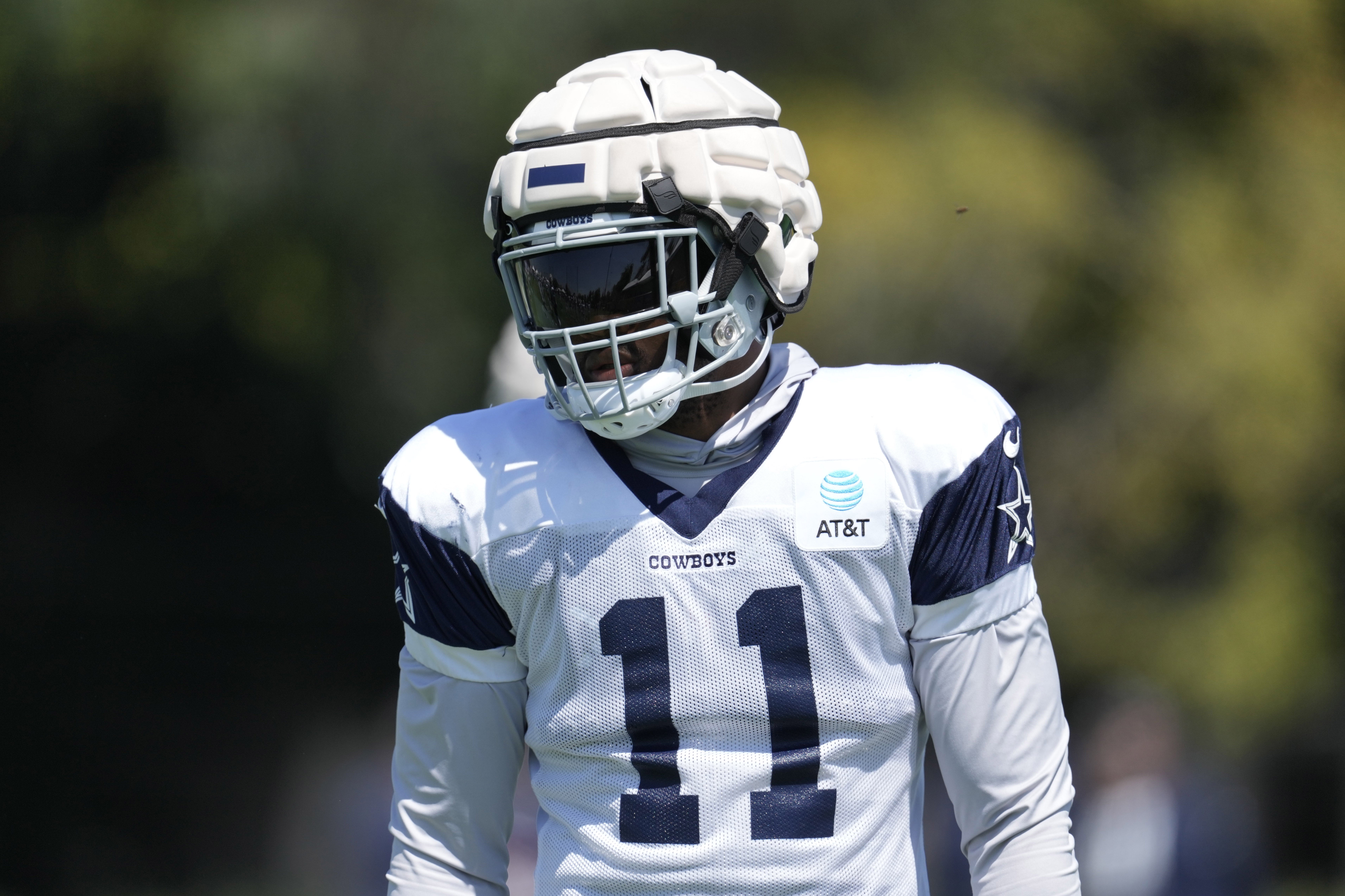 Dallas Cowboys linebacker Micah Parsons (11) wears a Guardian helmet cap during joint practice against the Los Angeles Chargers at Jack Hammett Sports Complex.