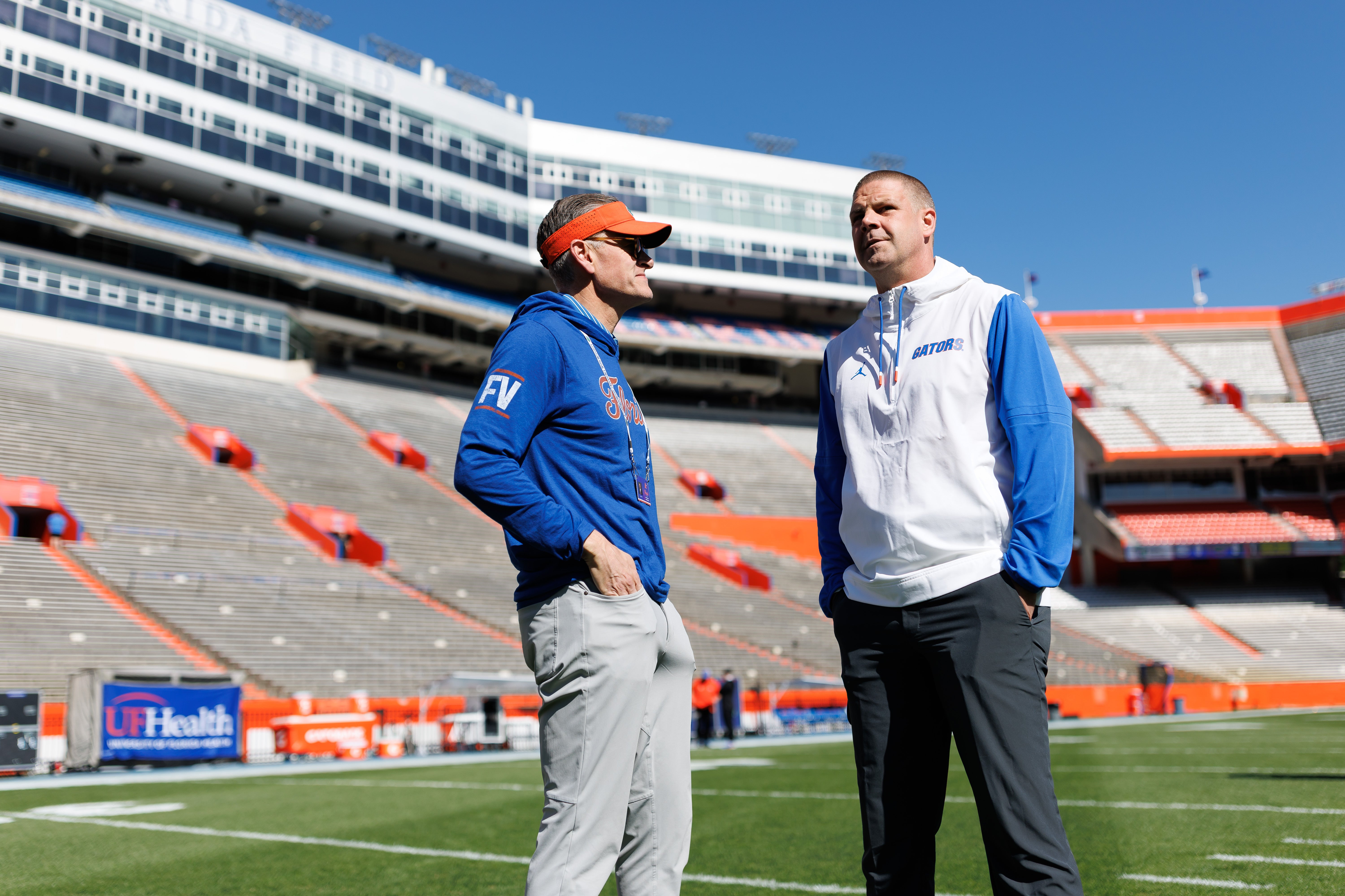 Apr 12, 2025; Gainesville, FL, USA; Florida Gators athletic director Scott Stricklin and Florida Gators head coach Billy Napier talk before the game at Ben Hill Griffin Stadium.