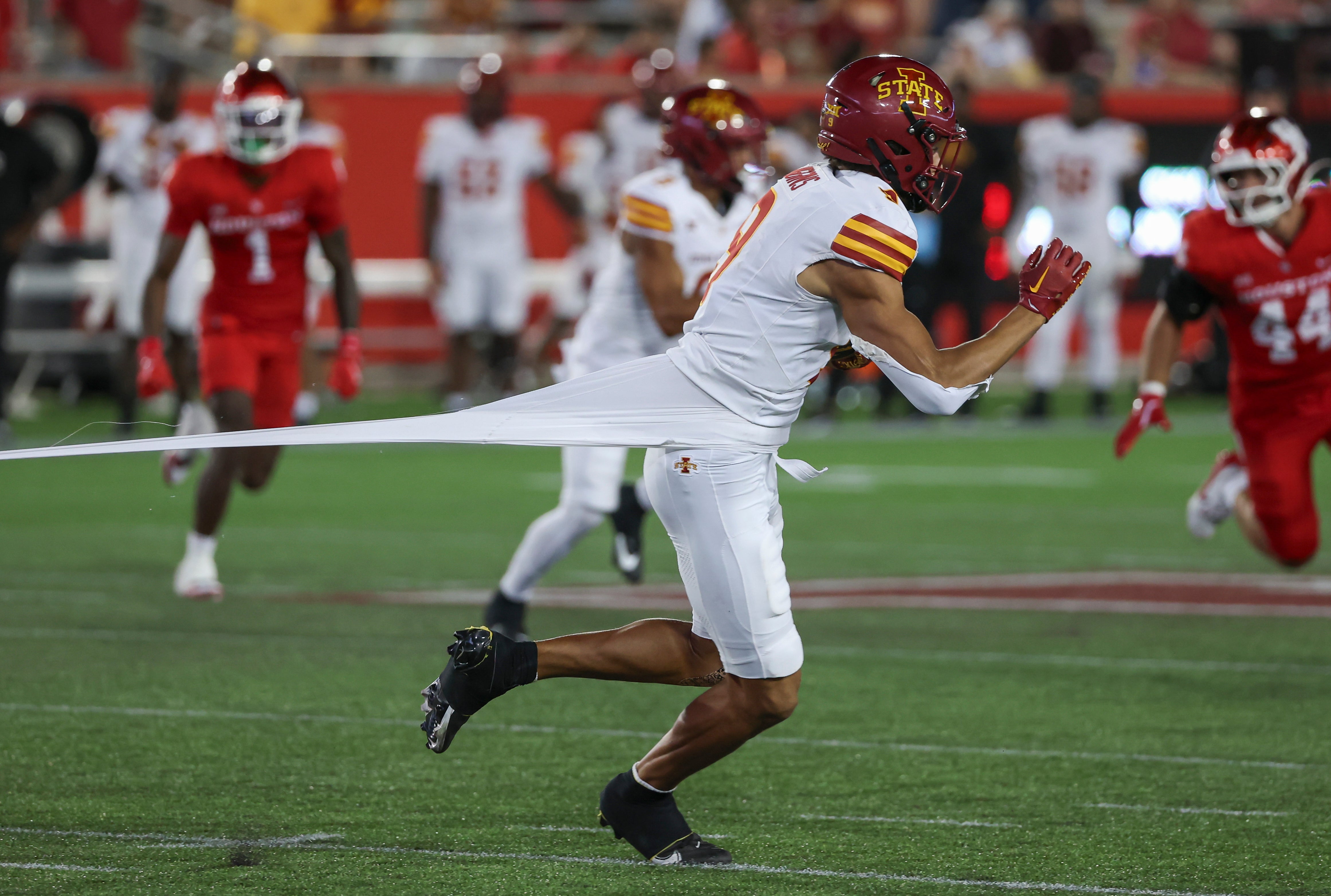 Iowa State Cyclones wide receiver Jayden Higgins (9) runs with the ball as a defender grabs his jersey during the third quarter against the Houston Cougars at TDECU Stadium.