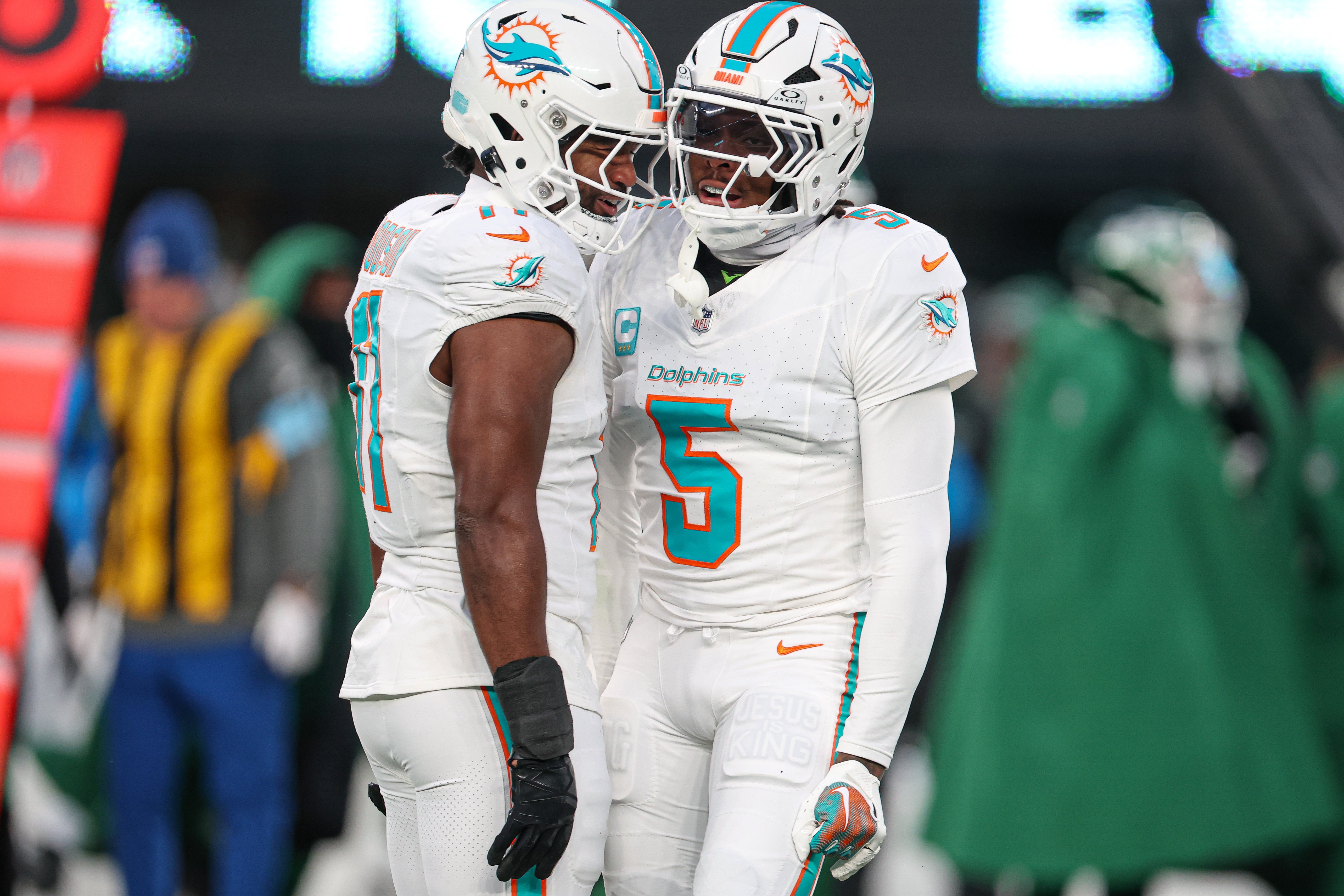Miami Dolphins cornerback Jalen Ramsey (5) celebrates a defensive stop with linebacker Tyrel Dodson (11) during the first quarteragainst the New York Jets at MetLife Stadium.