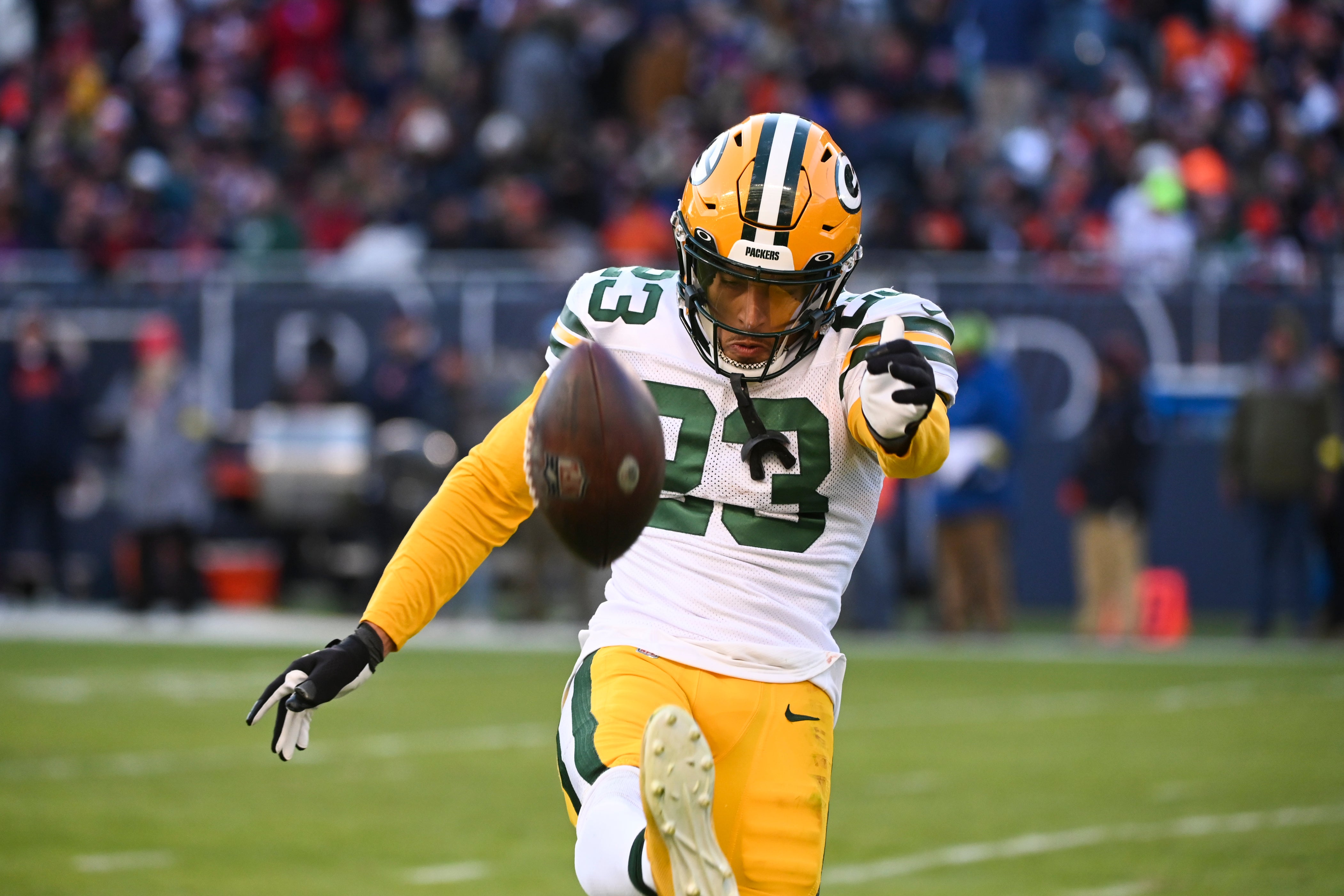 Green Bay Packers cornerback Jaire Alexander (23) kicks the ball into the stands after making an interception against the Chicago Bears during the second half at Soldier Field.
