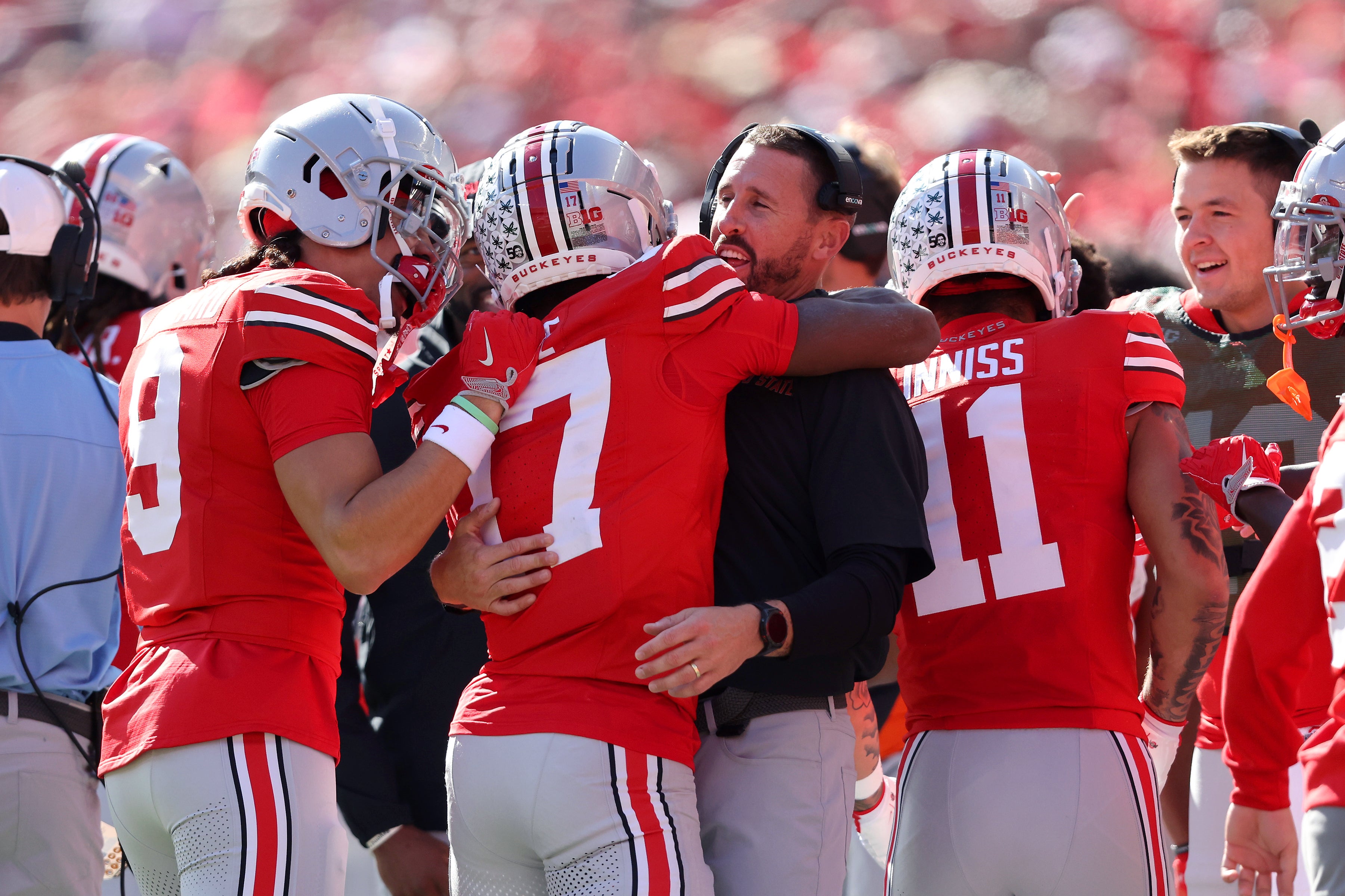 Oct 26, 2024; Columbus, Ohio, USA; Ohio State Buckeyes wide receiver Carnell Tate (17) celebrates a touchdown with Ohio State coach Brian Hartline during the first quarter against the Nebraska Cornhuskers at Ohio Stadium. Mandatory Credit: Joseph Maiorana-Imagn Images
