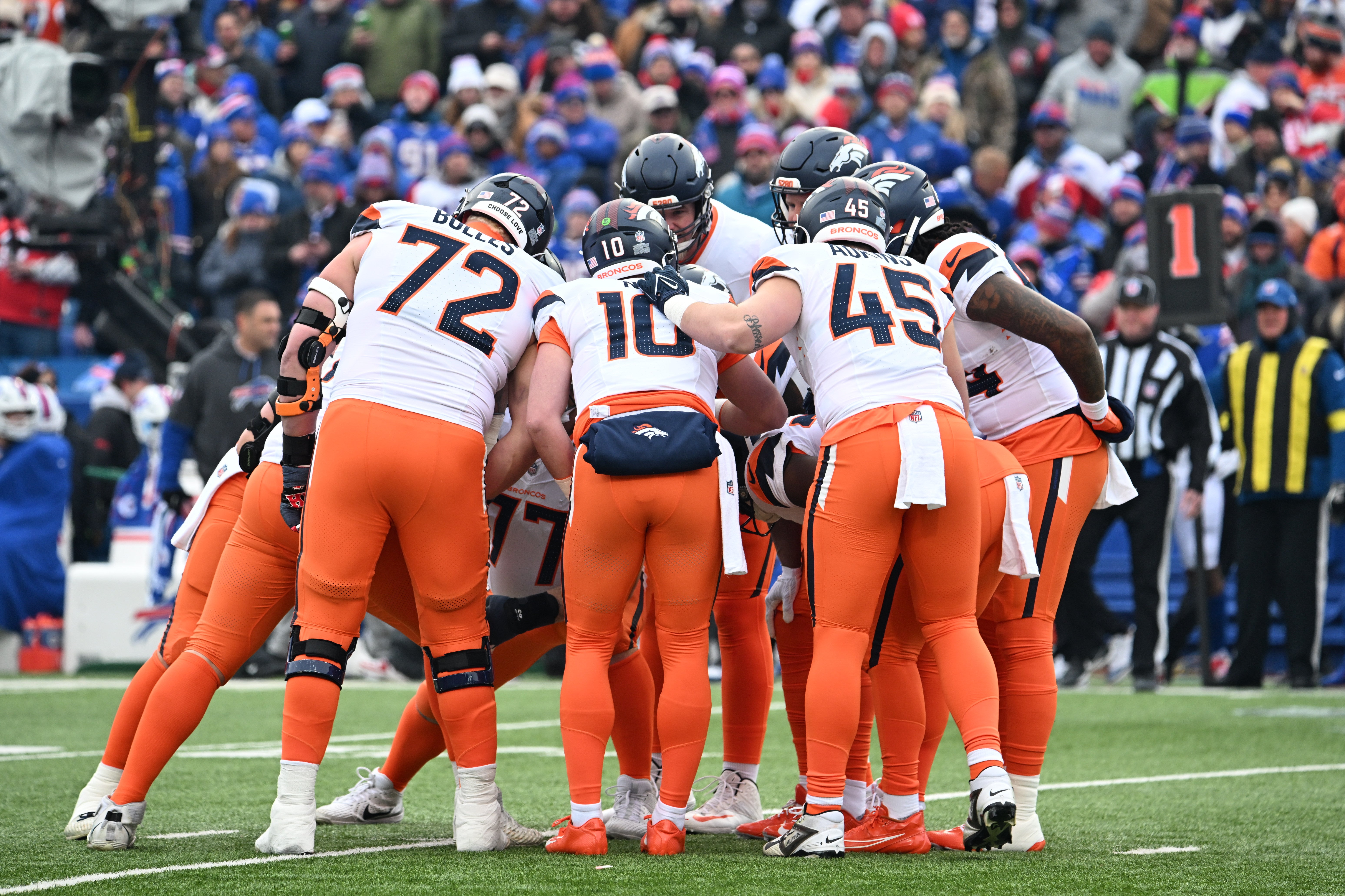 Jan 12, 2025; Orchard Park, New York, USA; The Denver Broncos huddle prior to the snap against the Buffalo Bills during the first quarter in an AFC wild card game at Highmark Stadium.