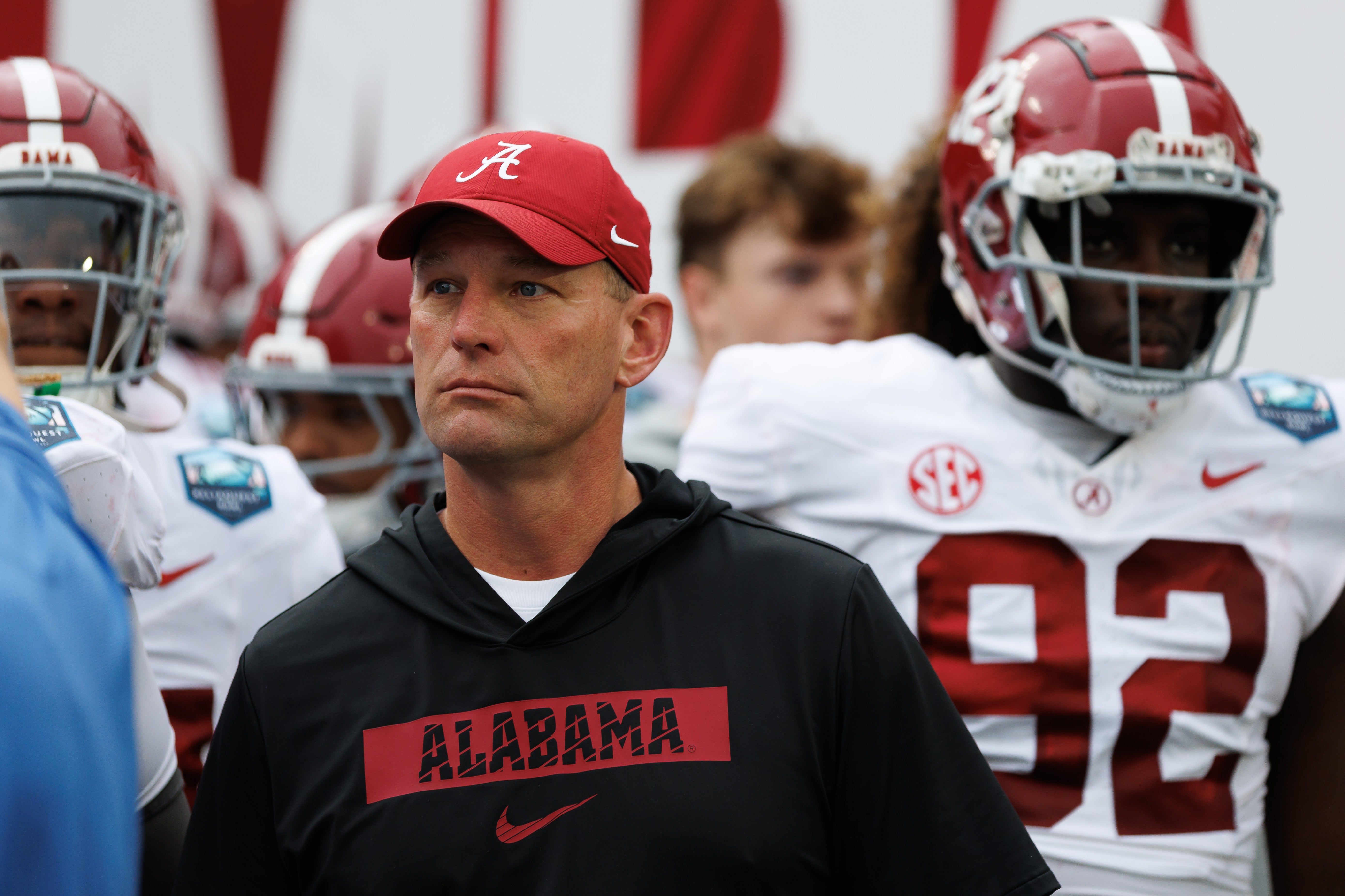 Kalen DeBoer, head coach of Alabama walking onto the field with his players for the bowl game against Michigan